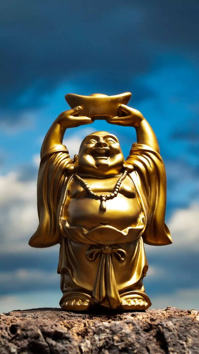 Grinende Buddhasten under den blå himmel Wallpaper