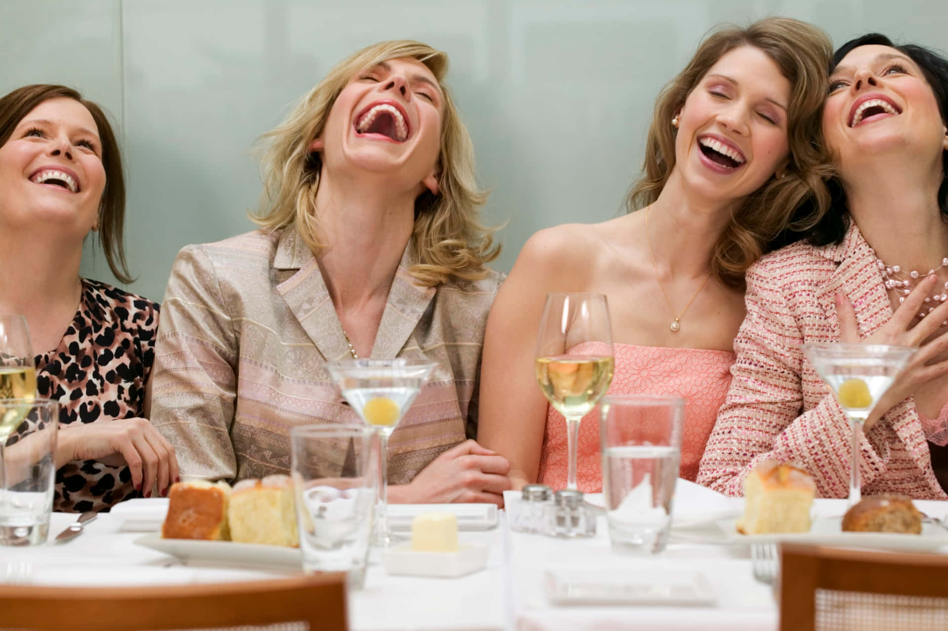 Kvinnorsom Skrattar Vid Ett Bord Med Vin Och Mat