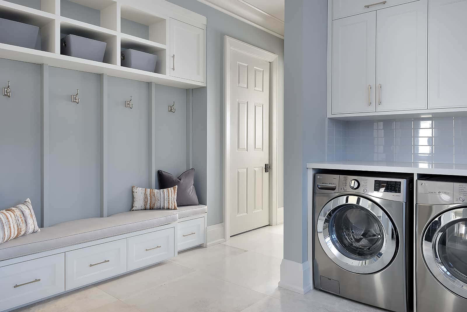 A Laundry Room With Washer And Dryer And Storage