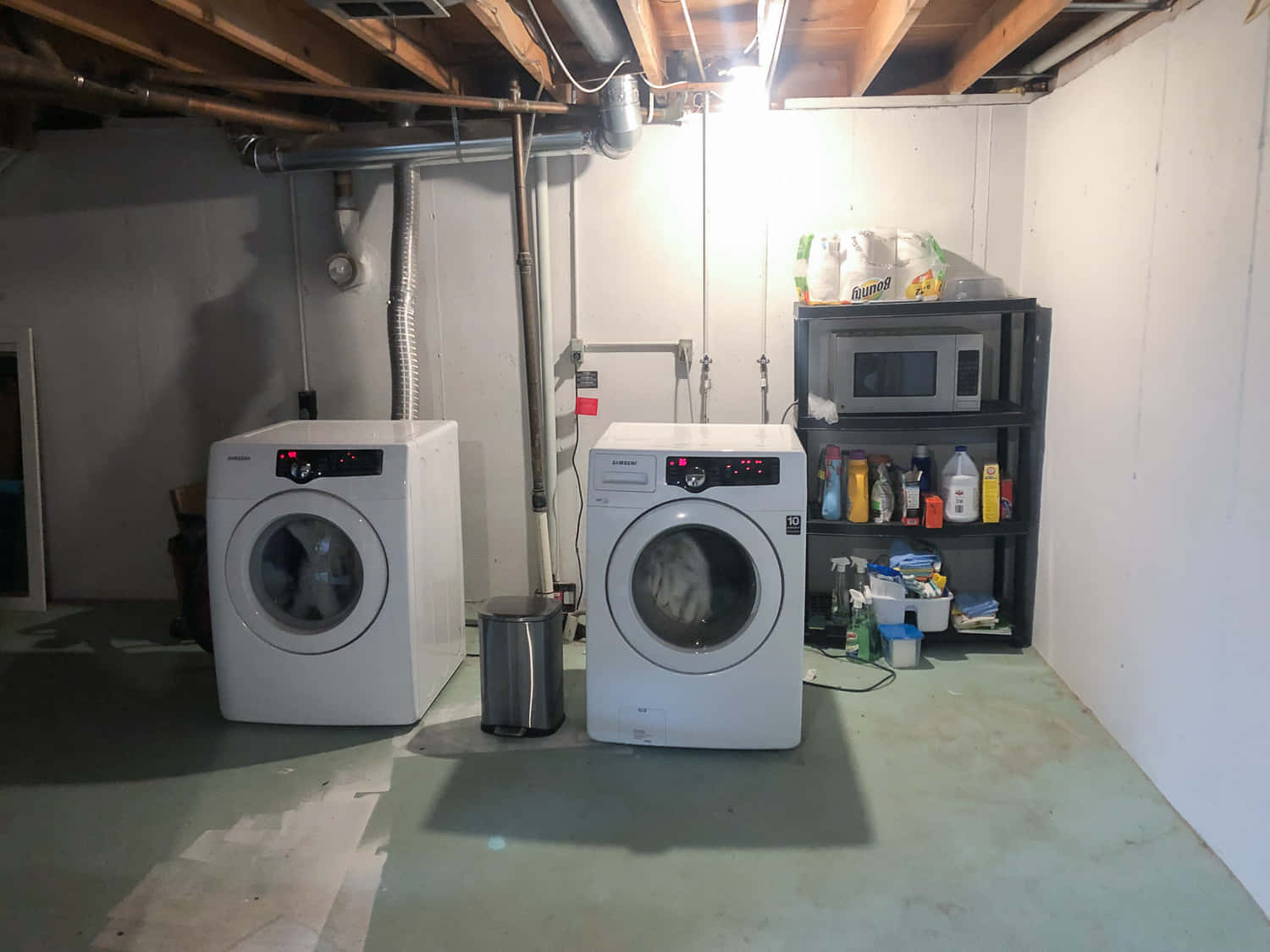 Two Washers And Dryers In A Basement