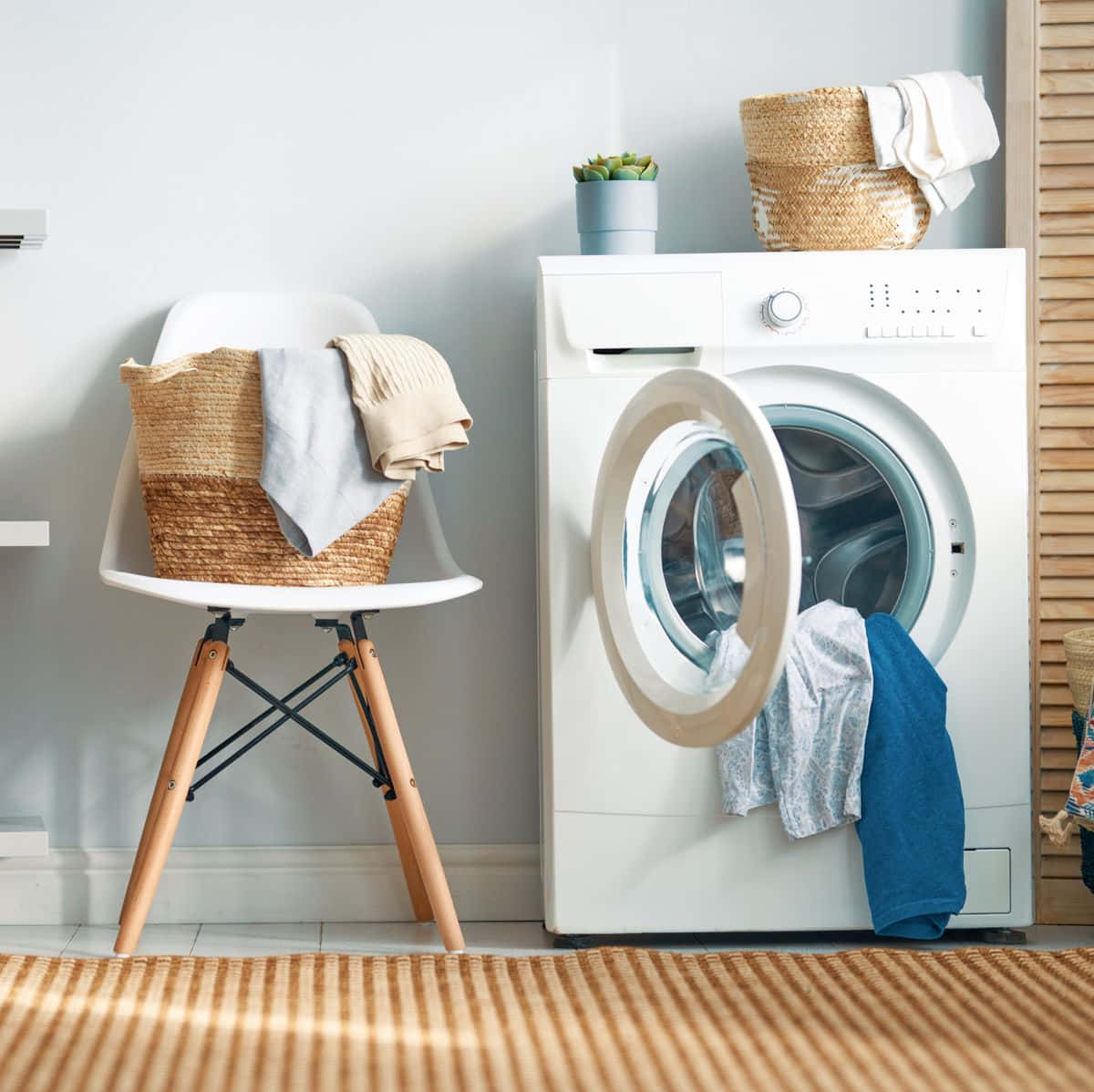 A White Washing Machine And Chair In A Room