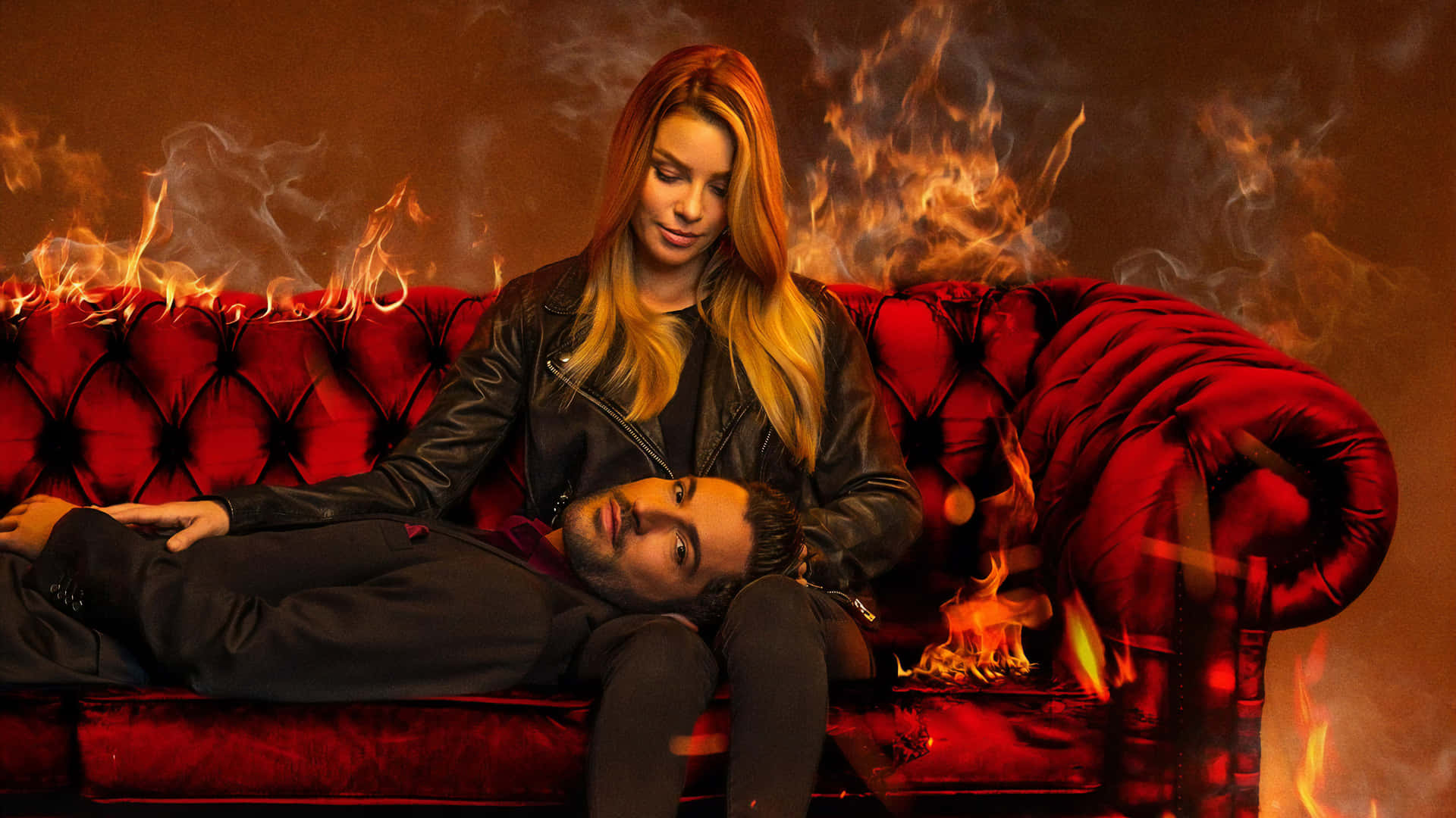 A Man And Woman Laying On A Red Couch With Fire Wallpaper