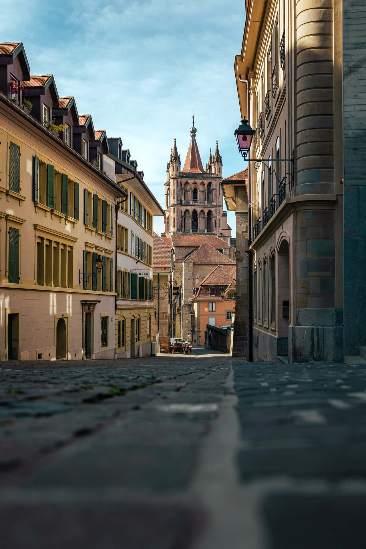 Download Lausanne Cobbled Streetand Cathedral Wallpaper | Wallpapers.com