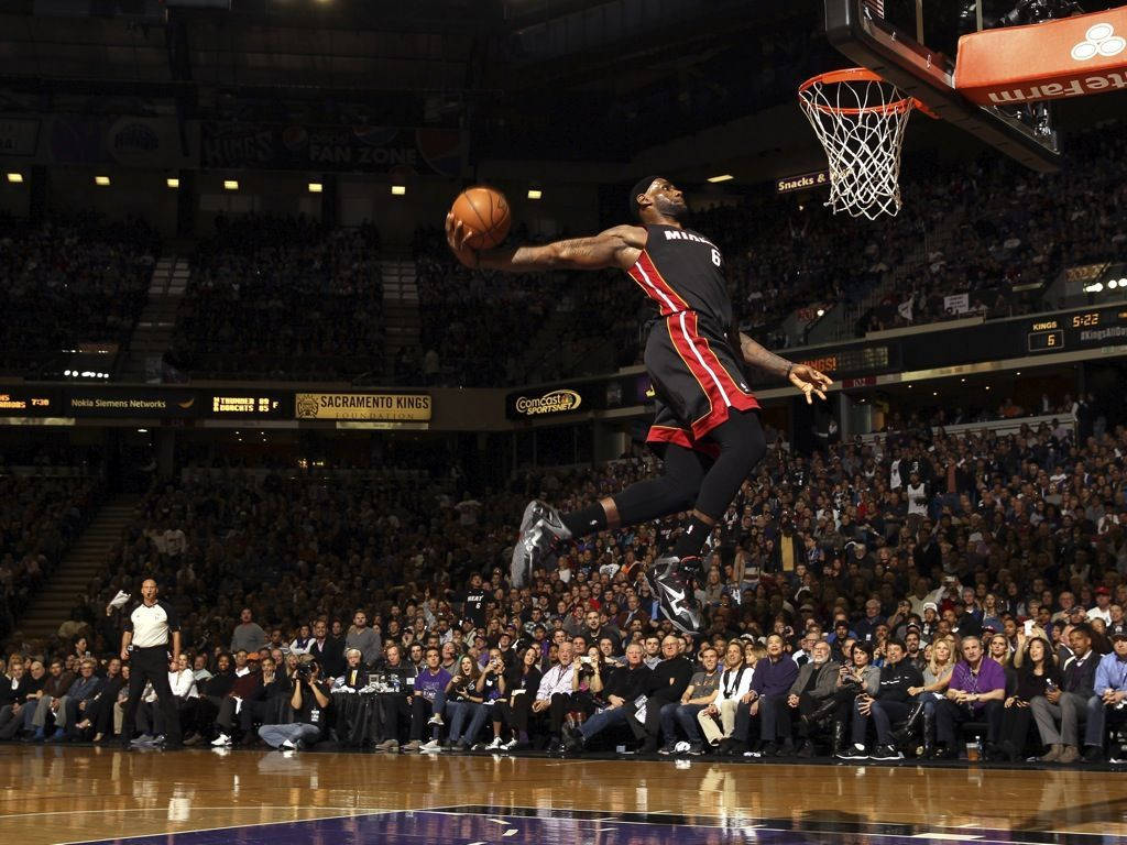 Download Lebron James dominating with a slam dunk in an iconic