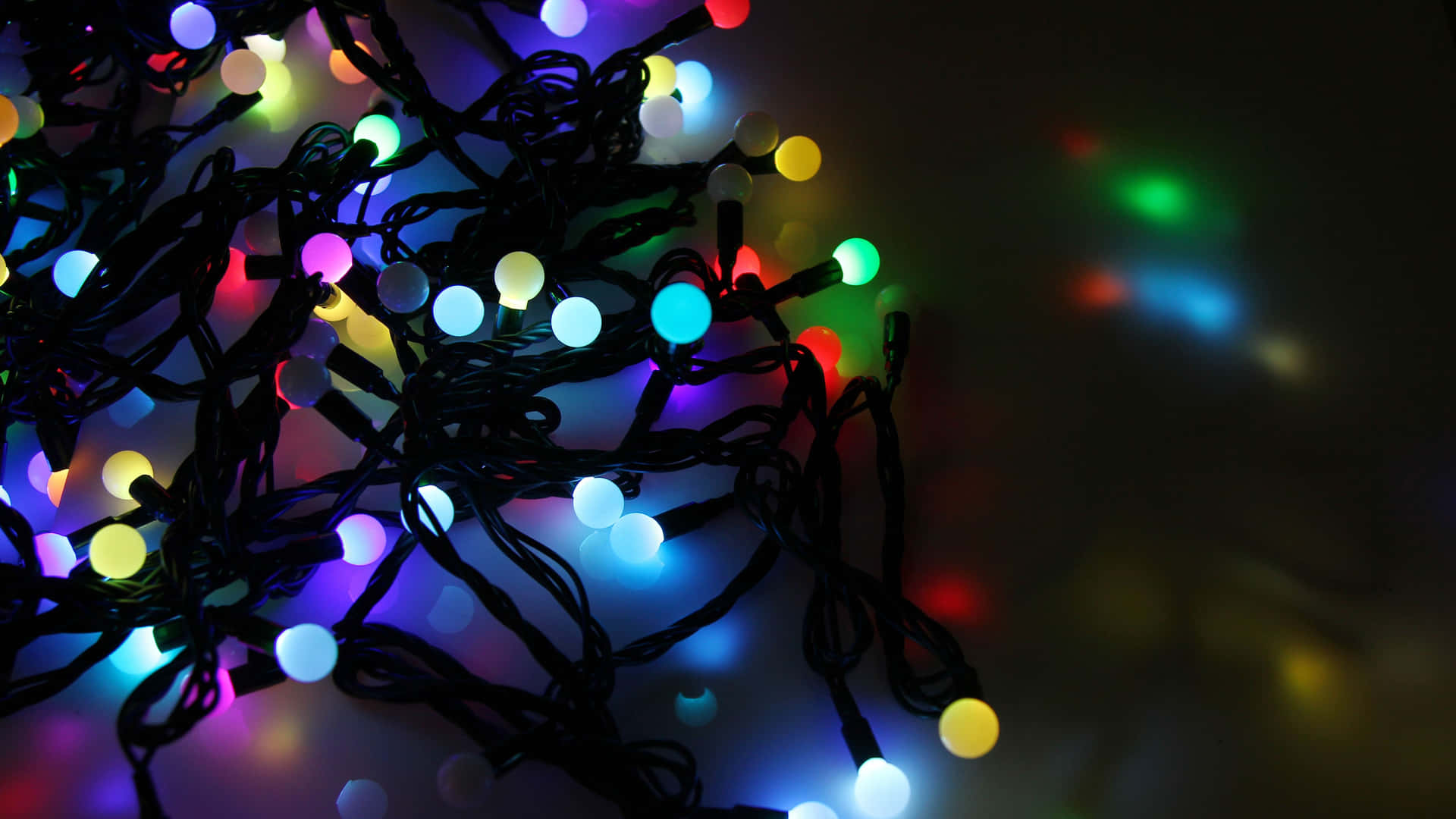 a bunch of multi colored lights on a white background