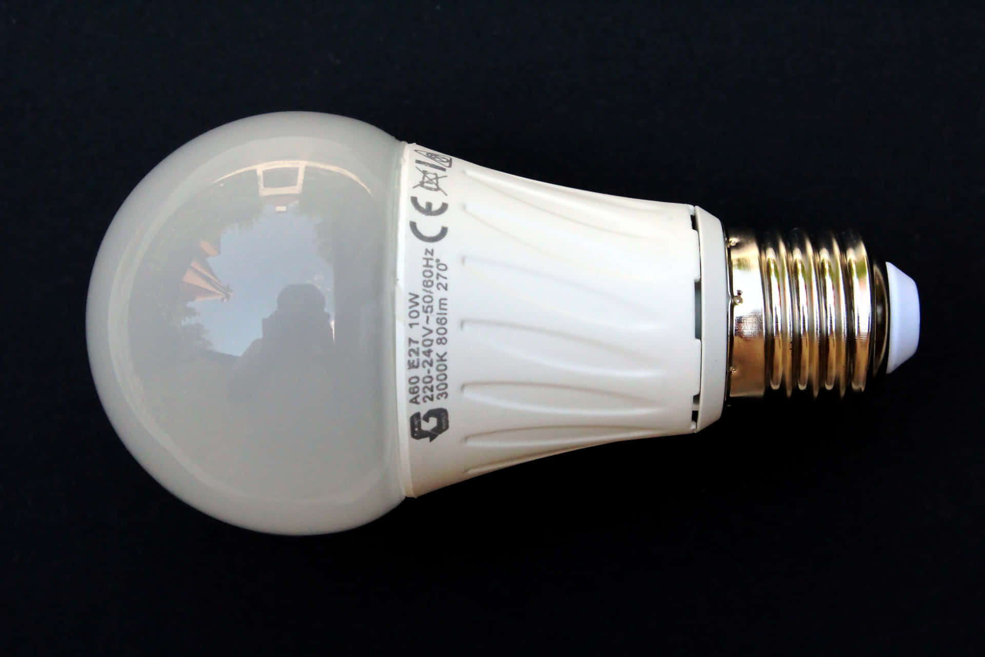 A White Led Light Bulb On A Black Surface