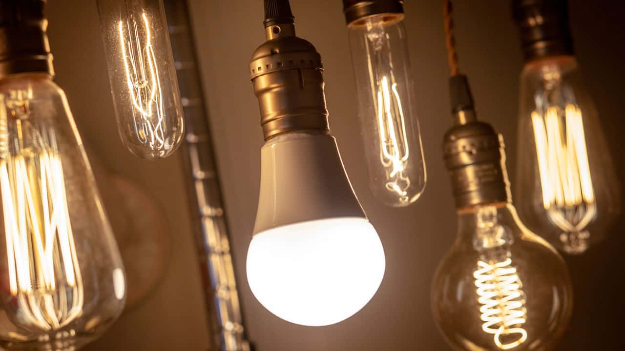 A Group Of Old Fashioned Light Bulbs Hanging From A Chain