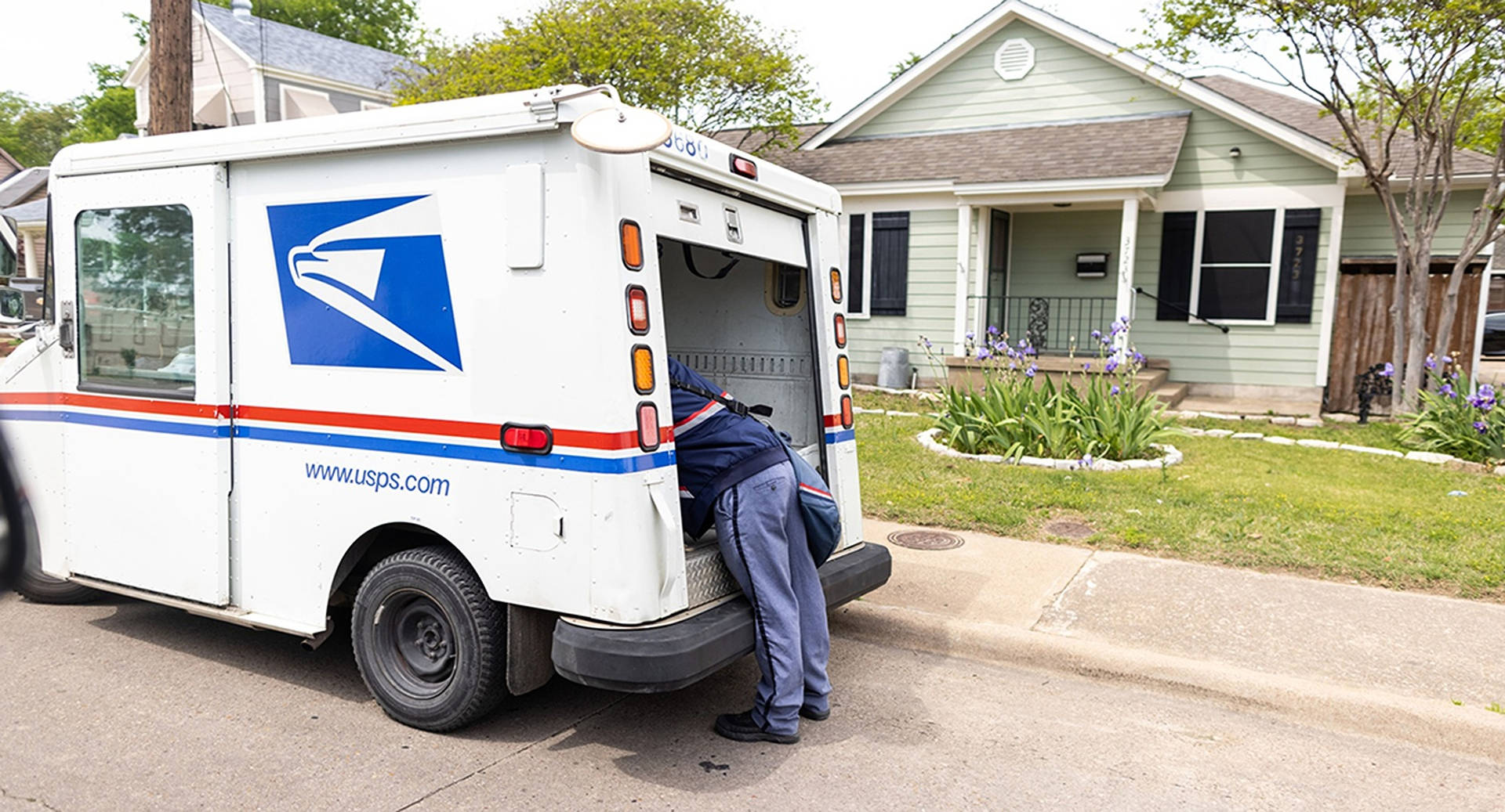 Legs Sticking From USPS Tracking Truck Wallpaper