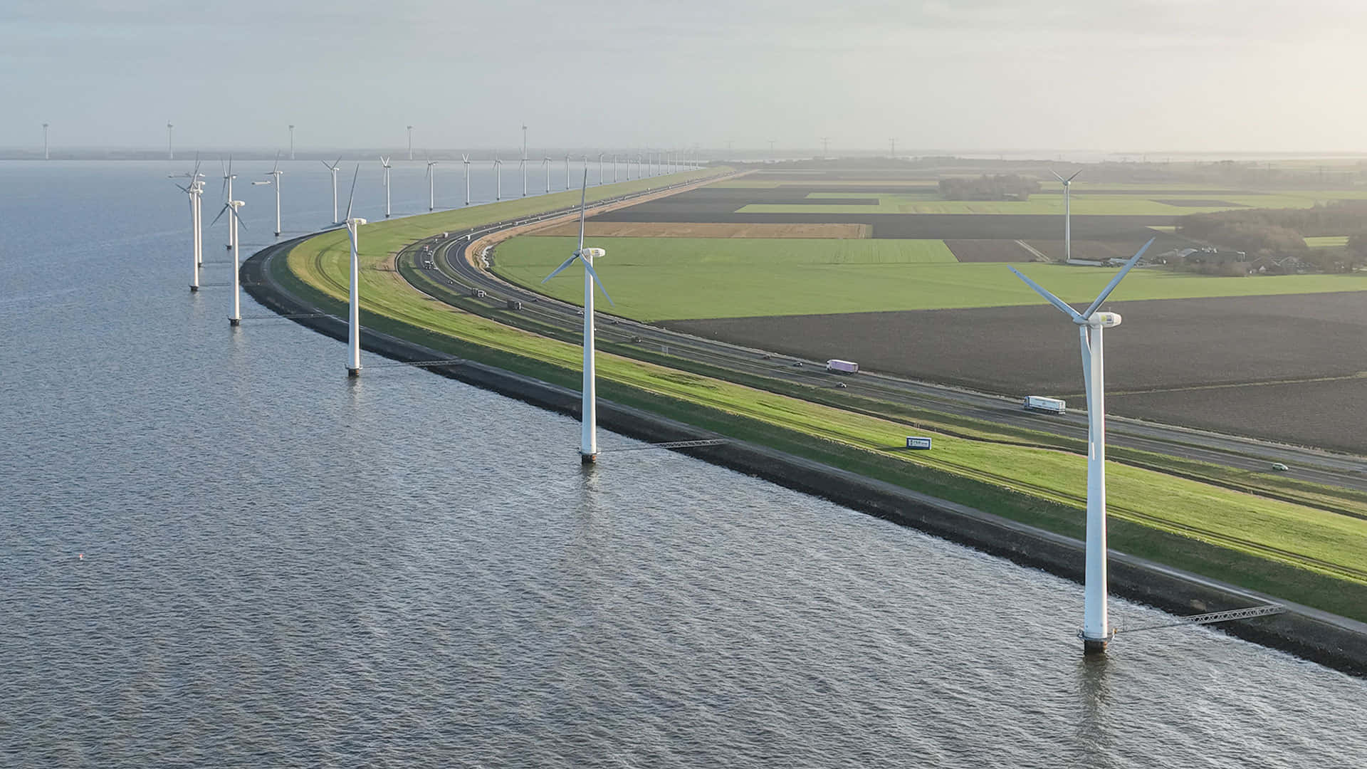 Lelystad Wind Turbines Along Waterway Wallpaper