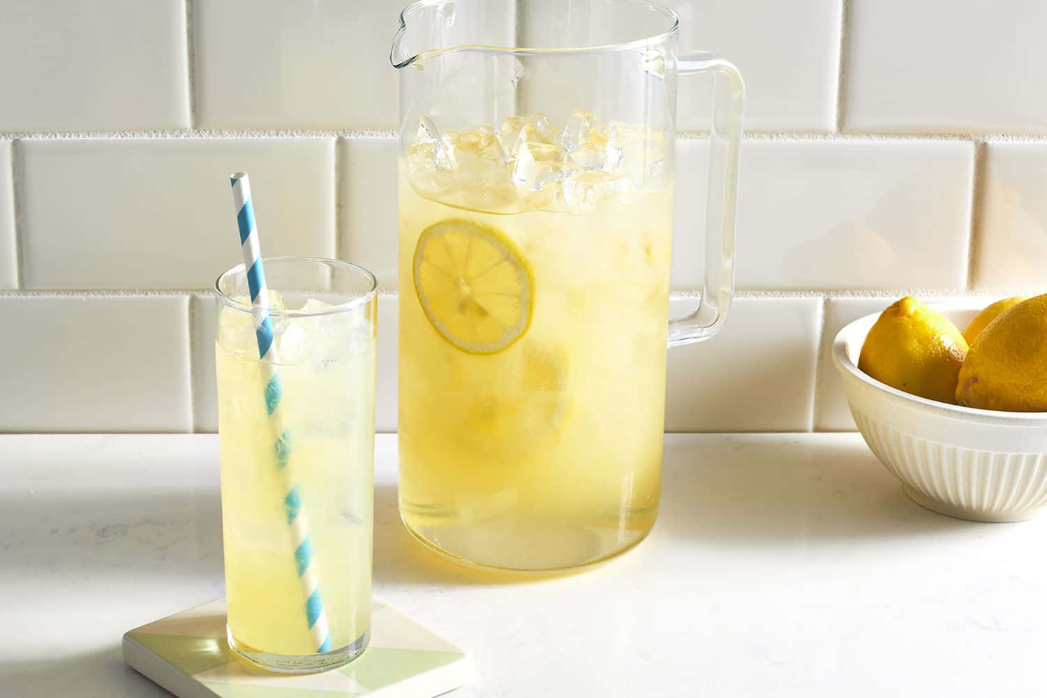 Lemonade Pitcher With Lemon Slices And A Glass Of Lemonade