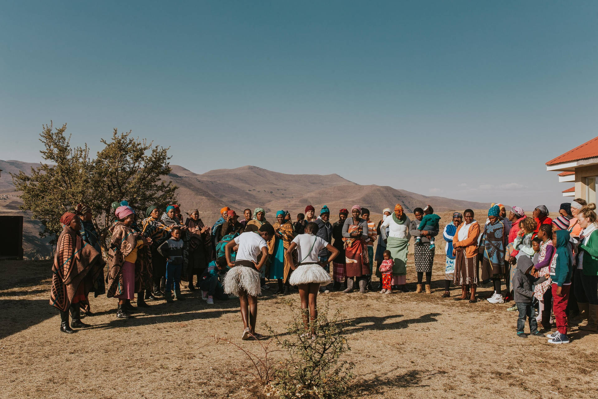 Joyful Gathering: Lesotho Girls Celebrating Tradition Through Dance Wallpaper