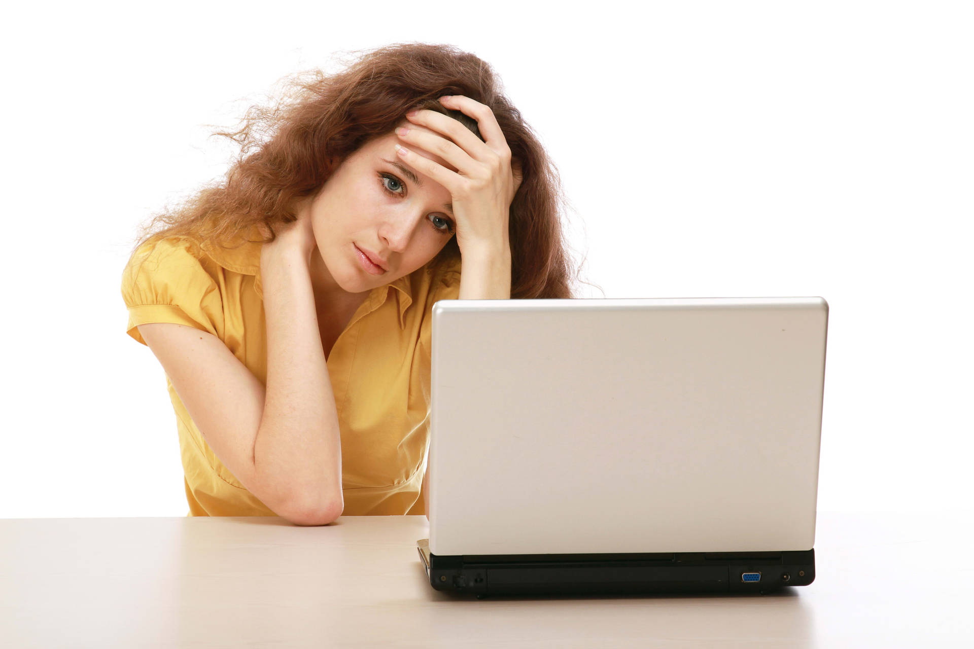 Uninspired Young Woman Staring Pensively at Laptop Screen Wallpaper