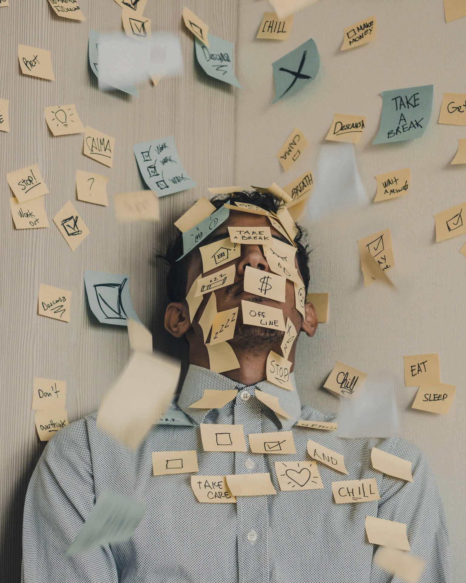 Overwhelmed Man Engulfed in Post-it Tasks Wallpaper