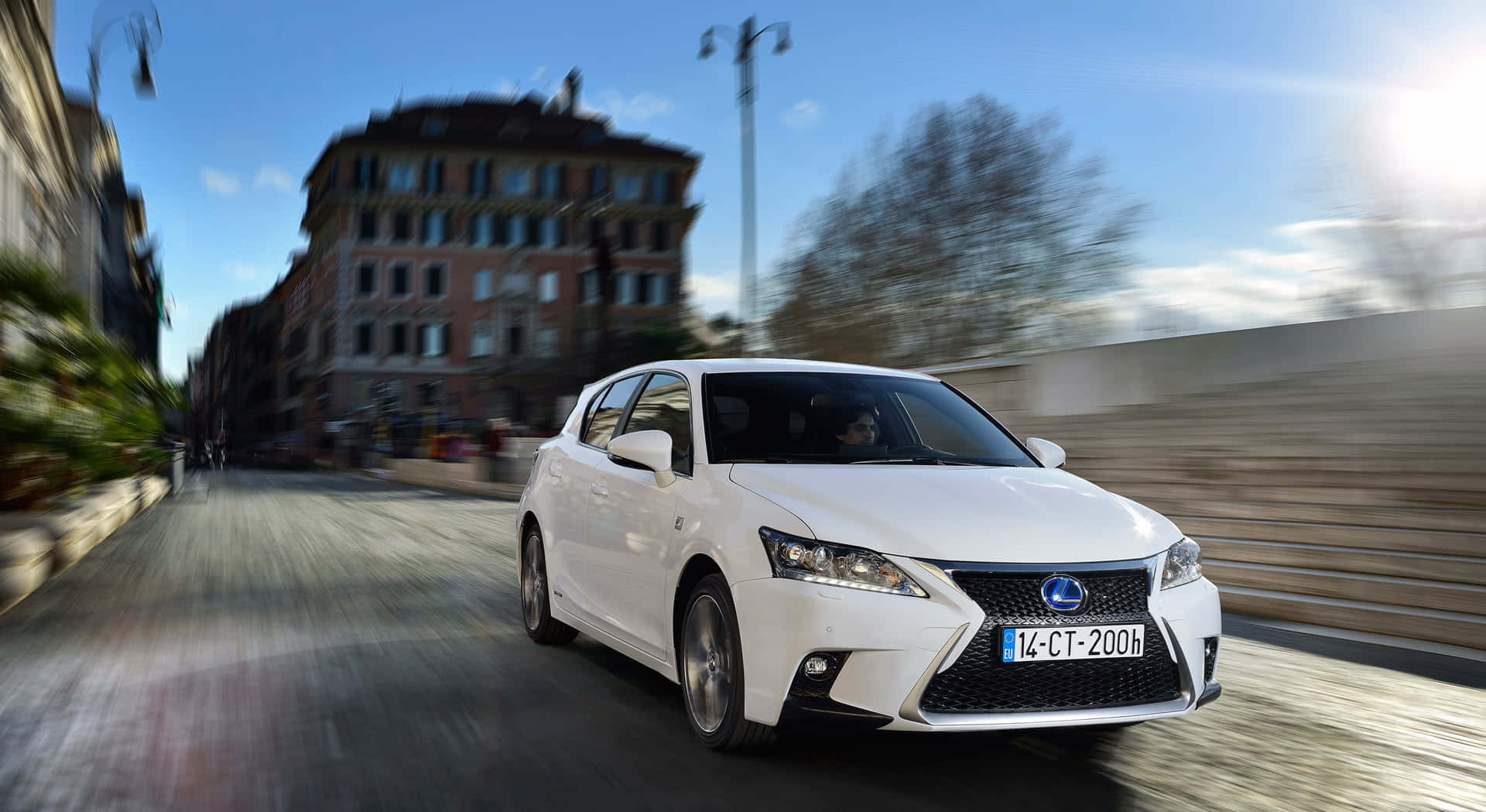 Sleek Lexus CT 200h Hybrid in a cityscape Wallpaper