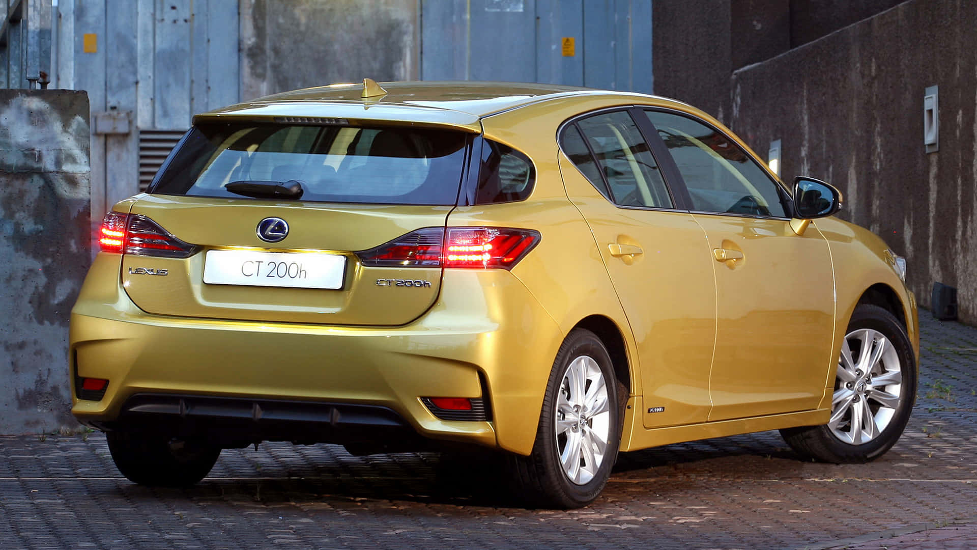 Sleek Lexus CT 200h gliding on a scenic road Wallpaper