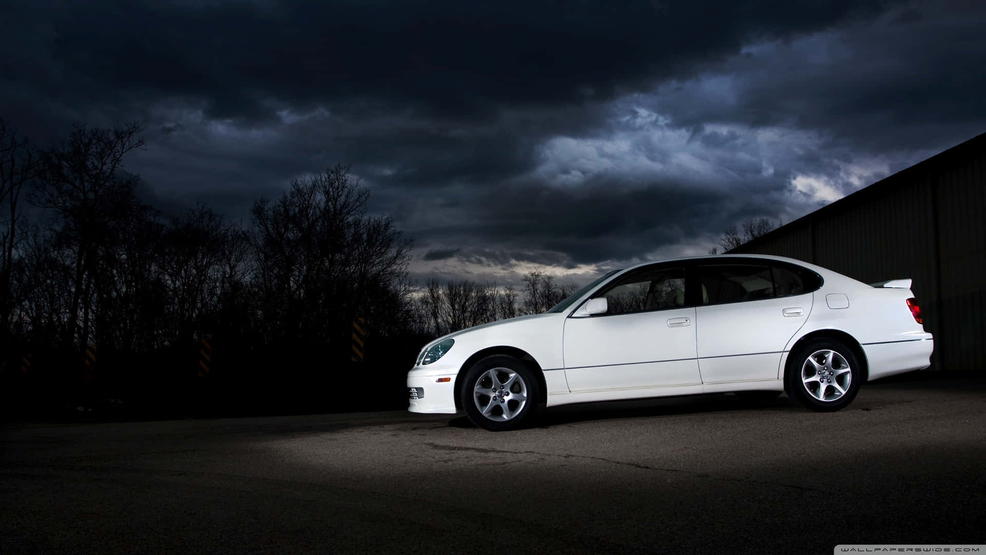 Caption: Sleek and Luxurious Lexus GS Cruising on the Road Wallpaper