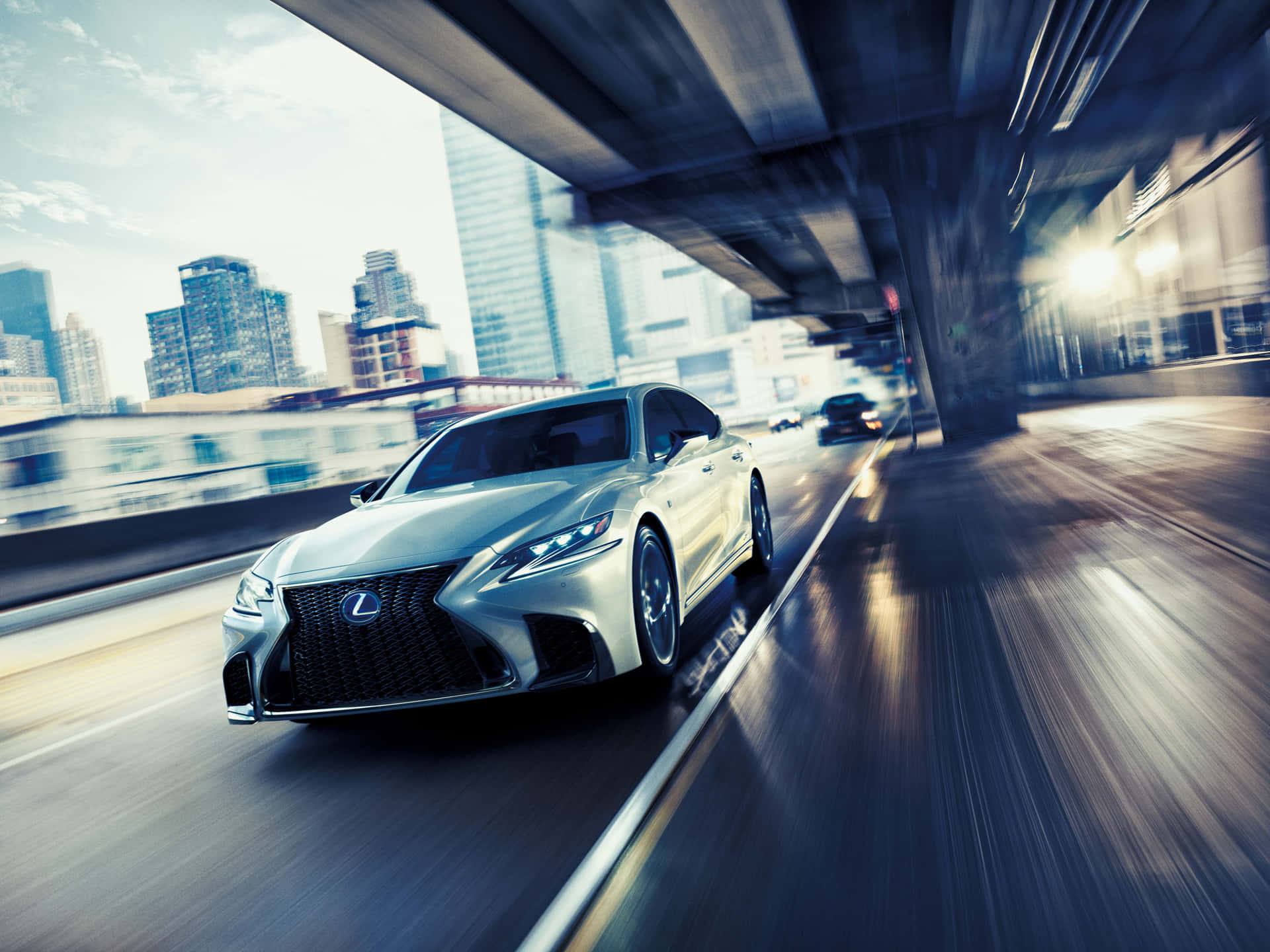Caption: A stunning Lexus LS 500 in motion on a scenic road. Wallpaper