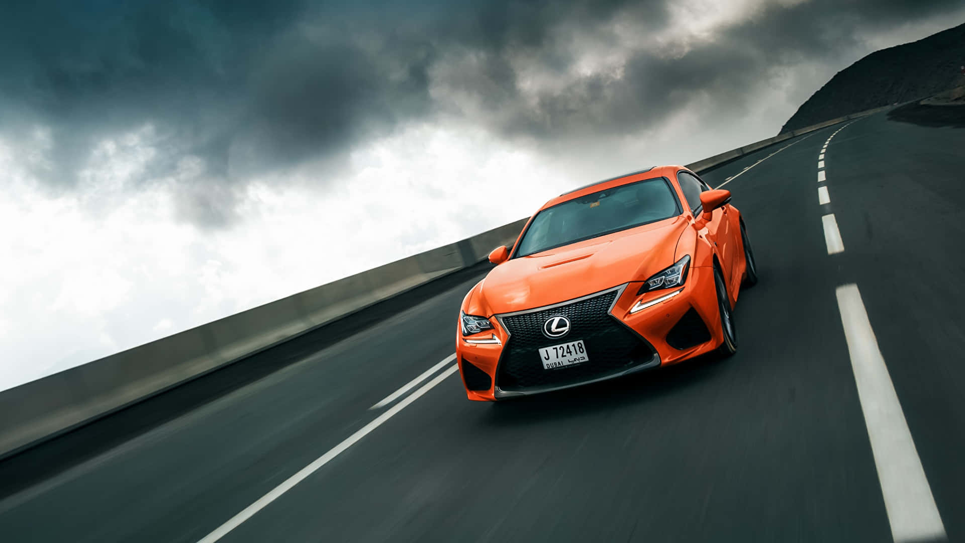 Powerful Lexus RC F showcasing its dynamic design and sporty stance. Wallpaper