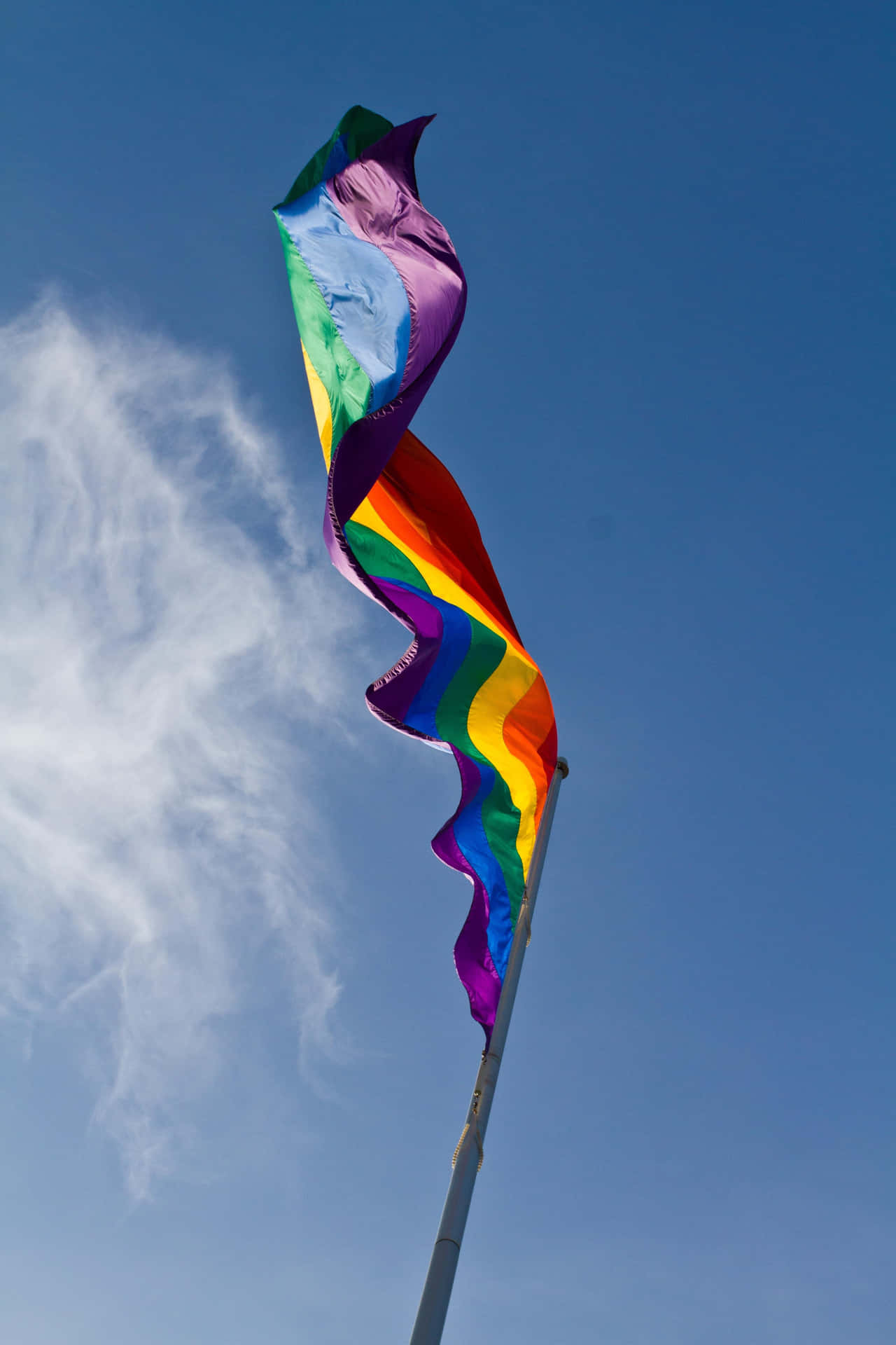A Rainbow Flag Flying In The Wind Wallpaper