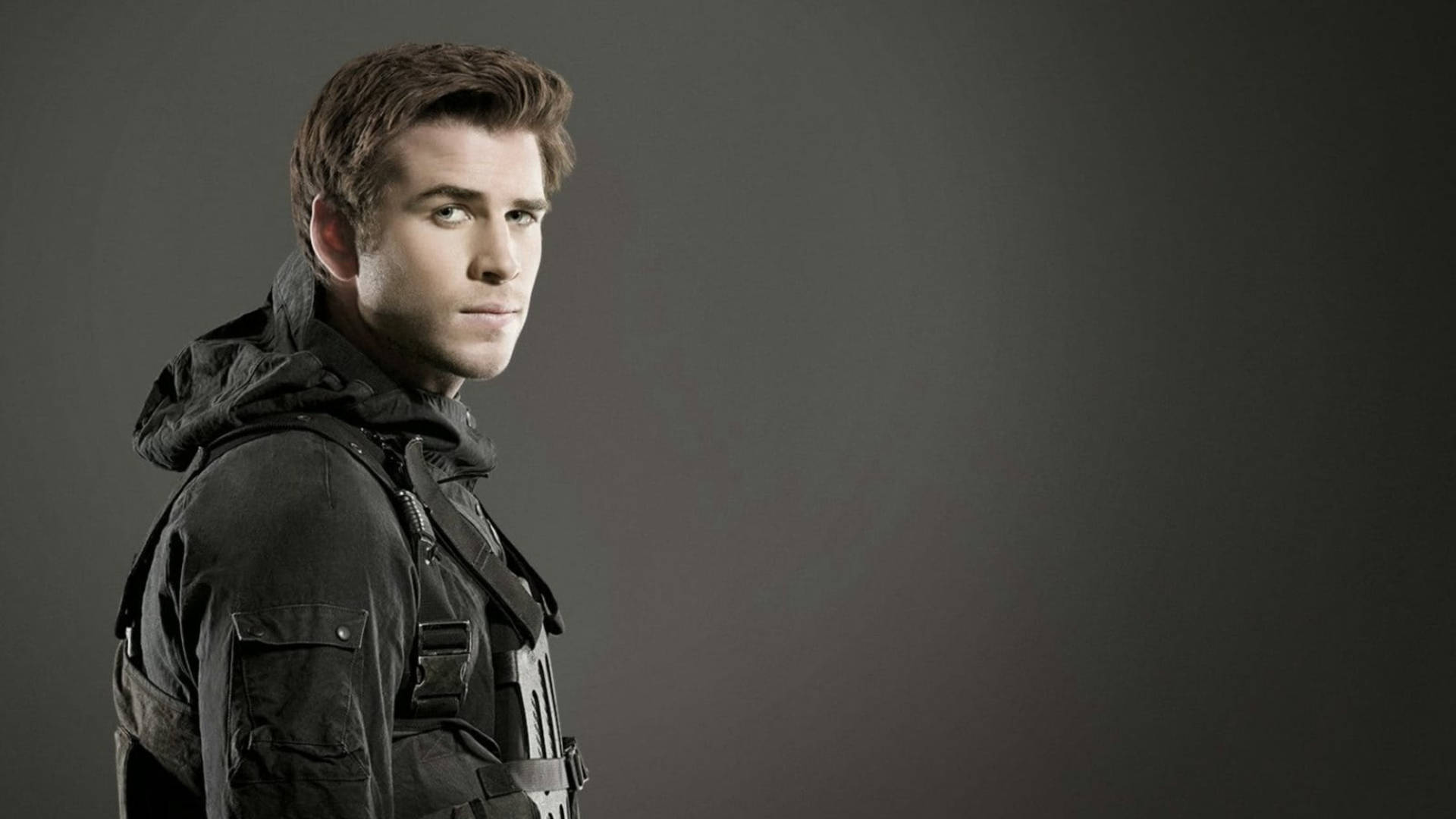 Liam Hemsworth Hunger Games Gray Background Wallpaper