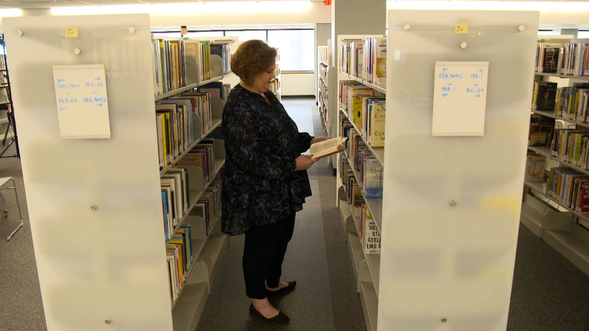 Librarian Holding A Book Wallpaper