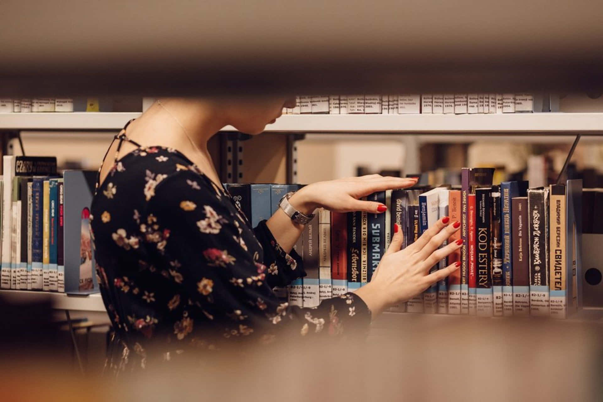 Woman Picking A Book In A Library Picture