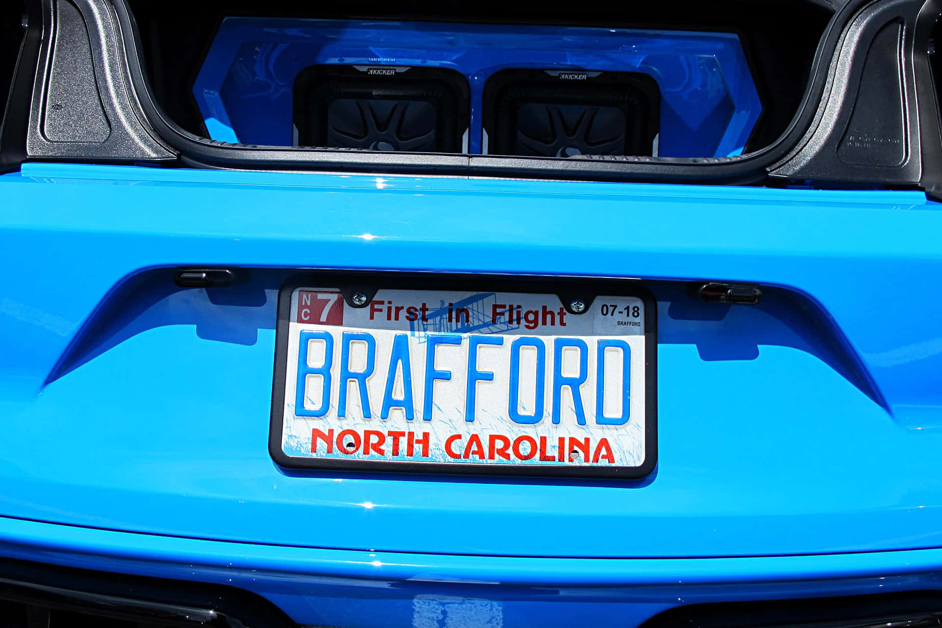 A Blue Car With A License Plate
