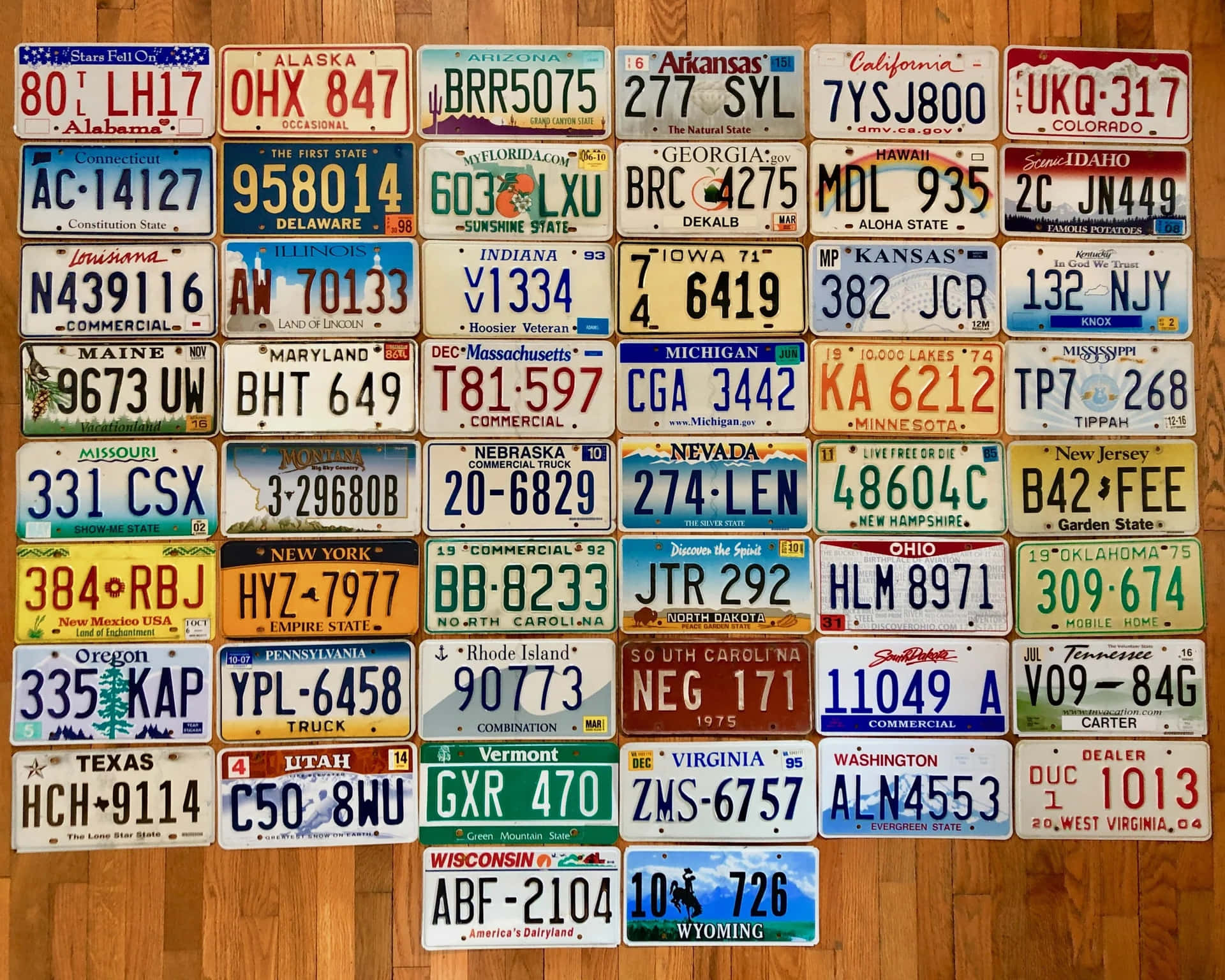 A Collection Of License Plates On A Wooden Floor