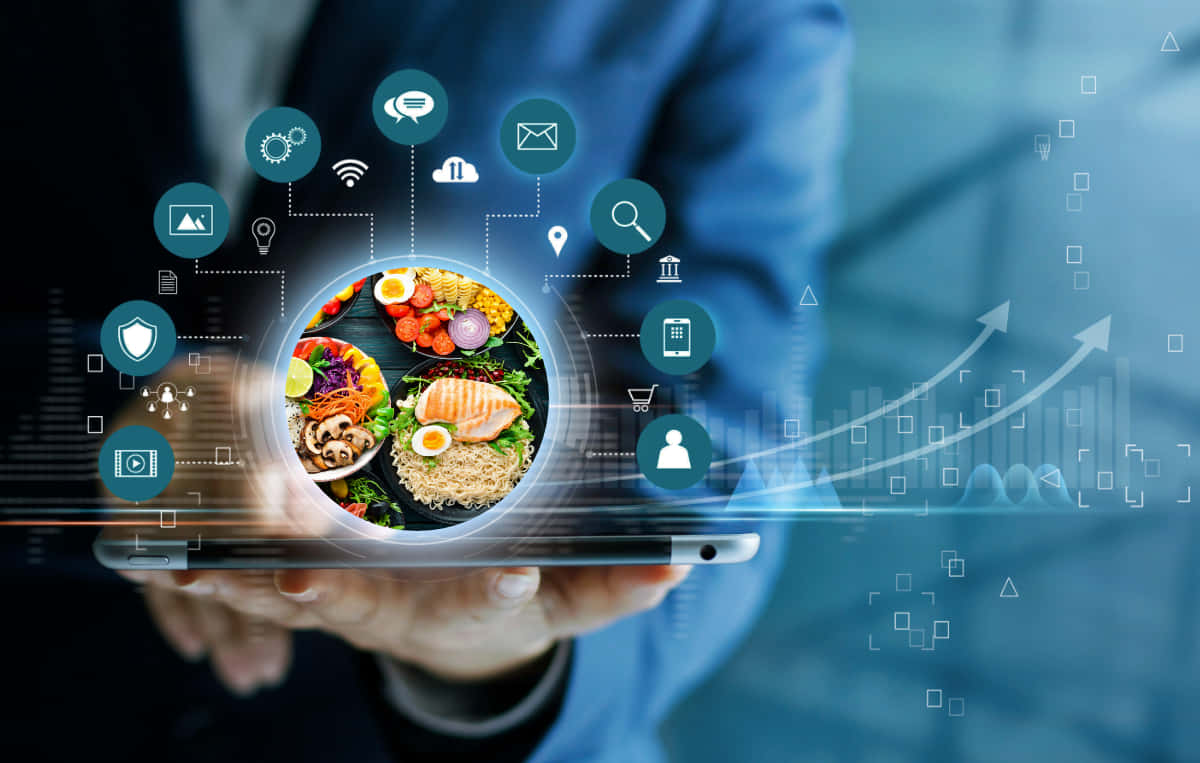 A Businessman Holding Up A Tablet With Food Icons On It