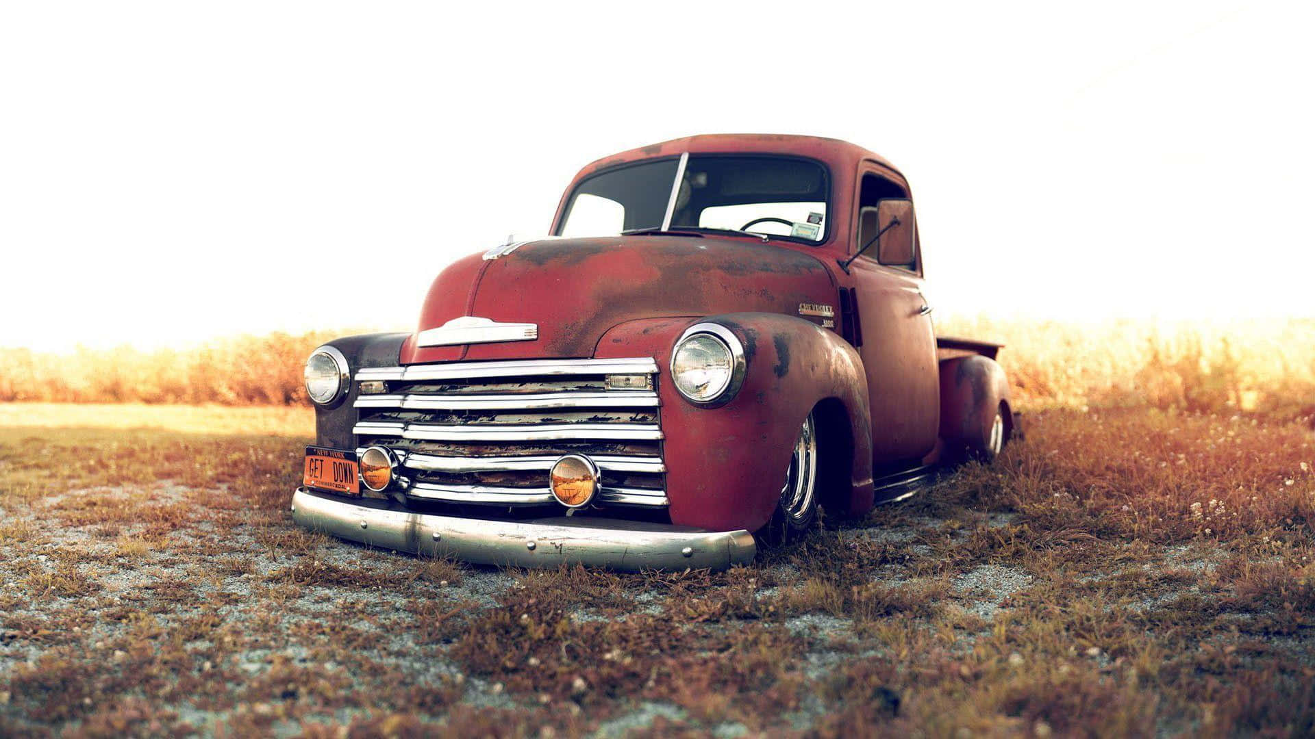 Red Lifted Truck On The Field Wallpaper