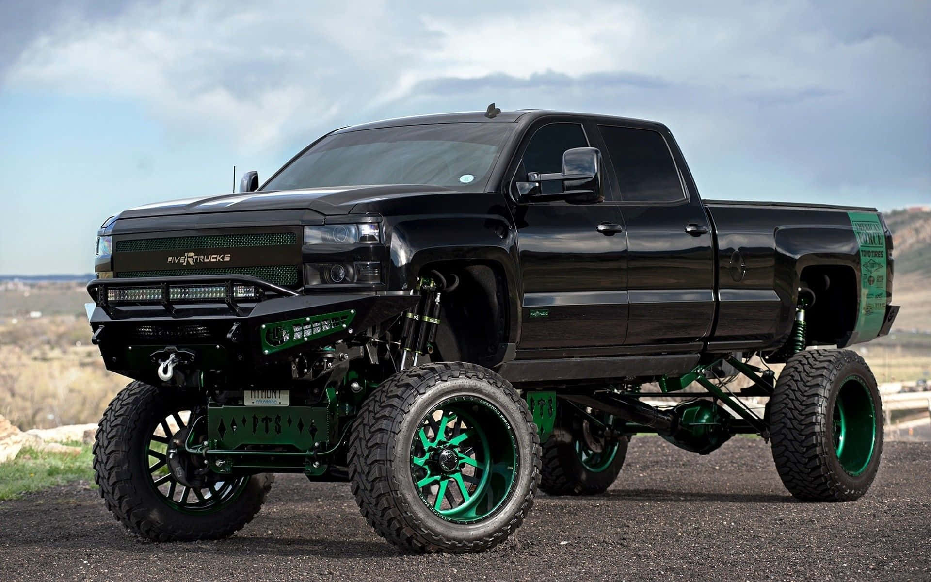 Black Lifted Truck With Green Wheels Wallpaper