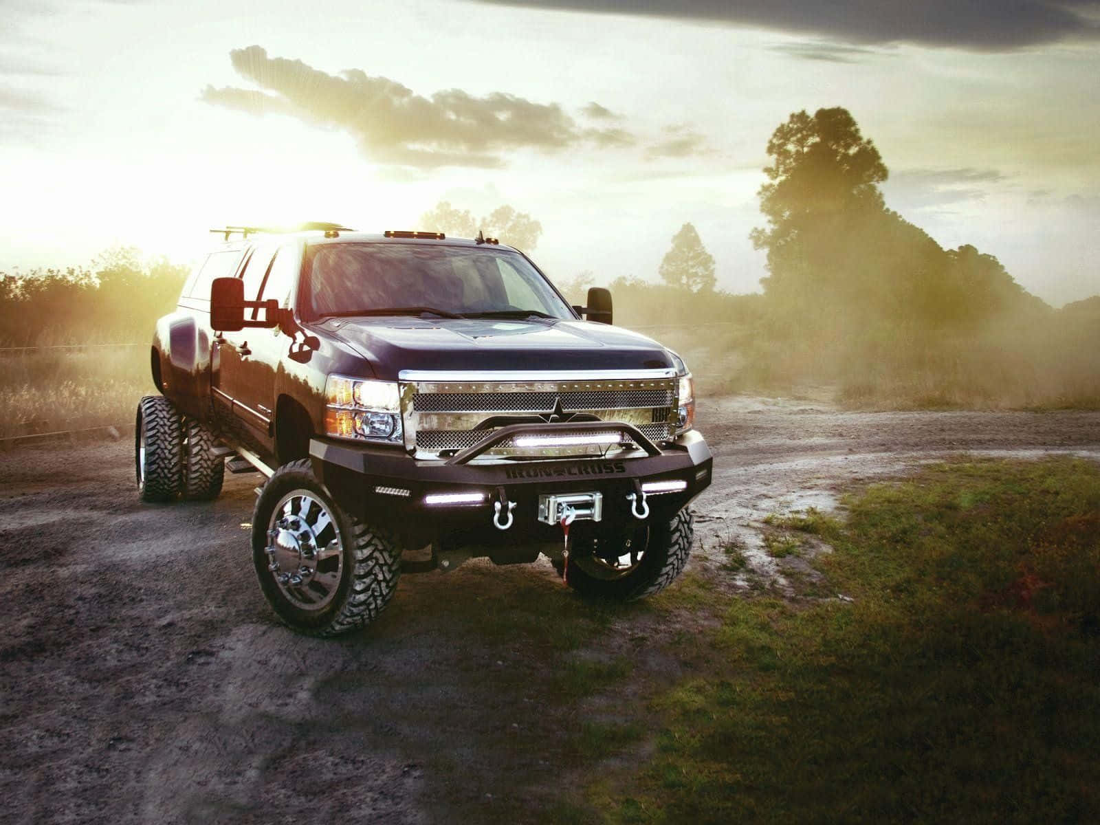 Lifted Truck On A Dirt Road Wallpaper