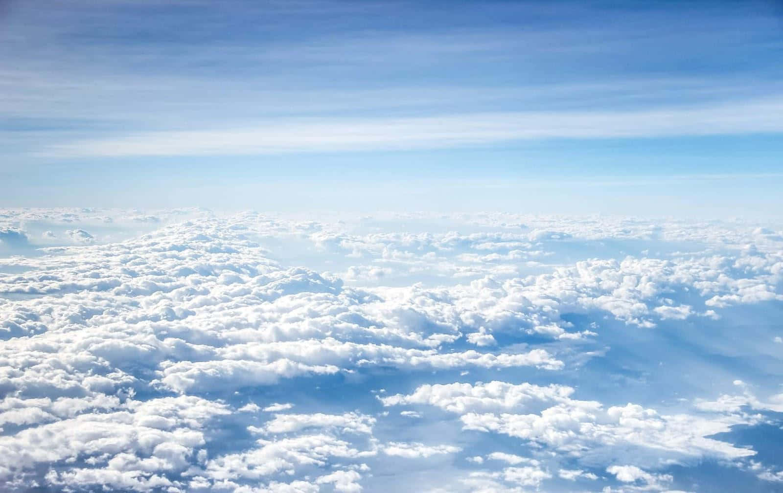 A View Of Clouds From An Airplane Window Wallpaper
