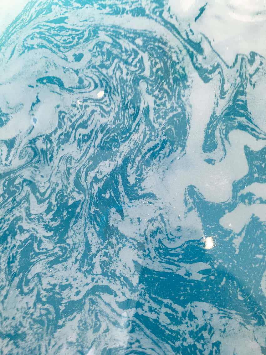 A Close Up Of A Blue And White Liquid Wallpaper