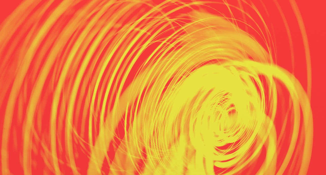A Yellow And Orange Spiral With A Red Background
