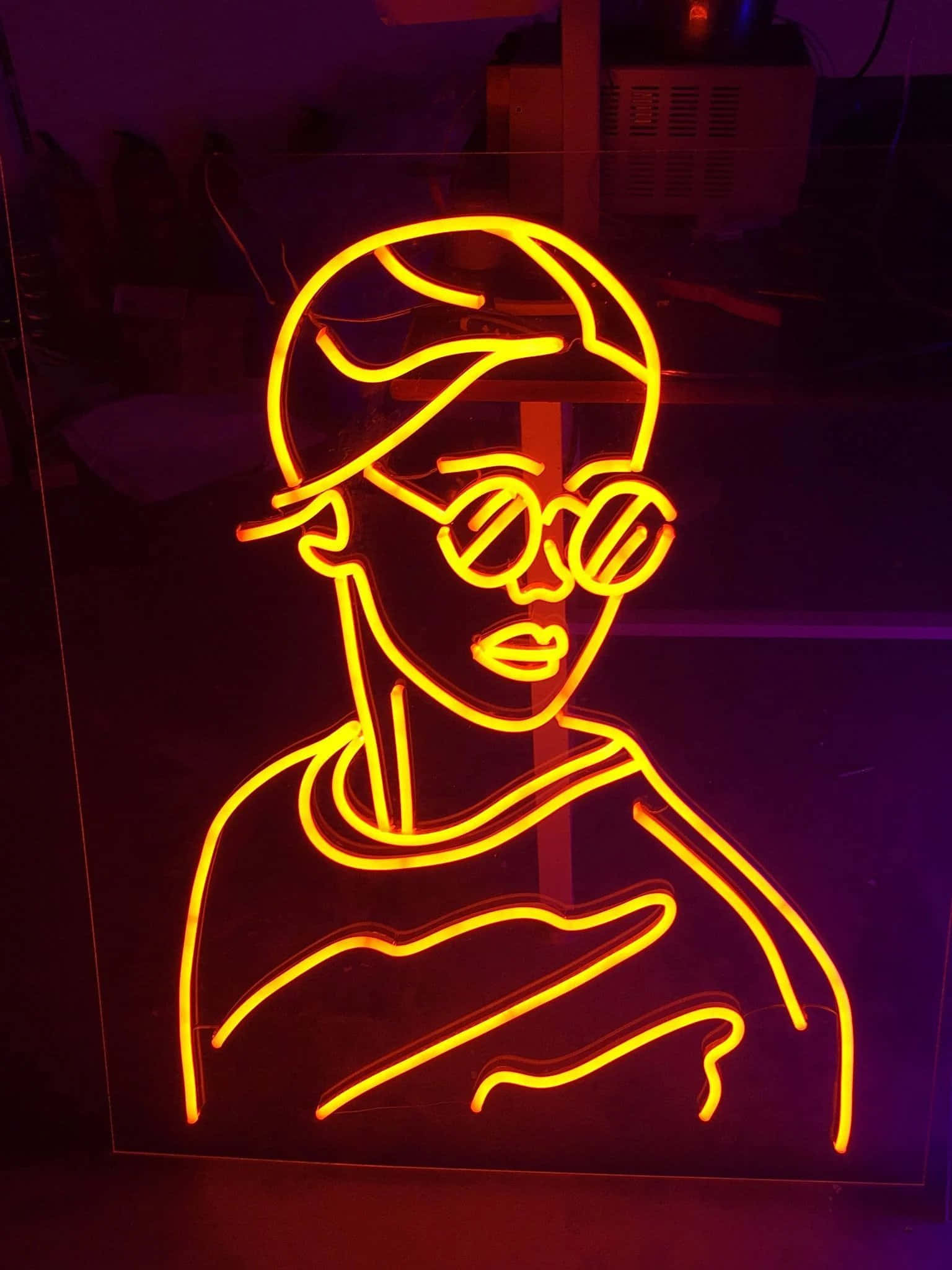A Neon Sign With A Woman In Glasses