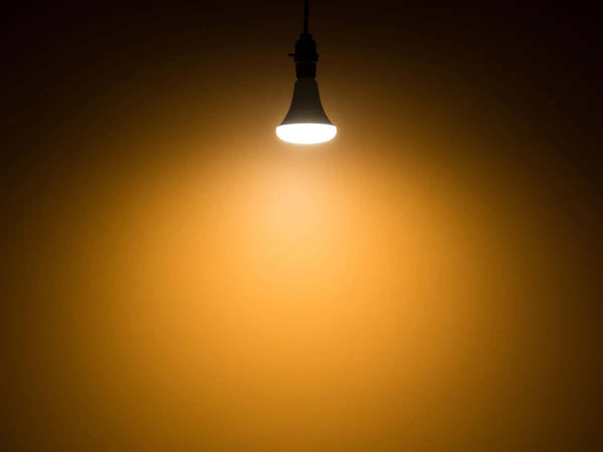 A Light Bulb Is Hanging In A Dark Room