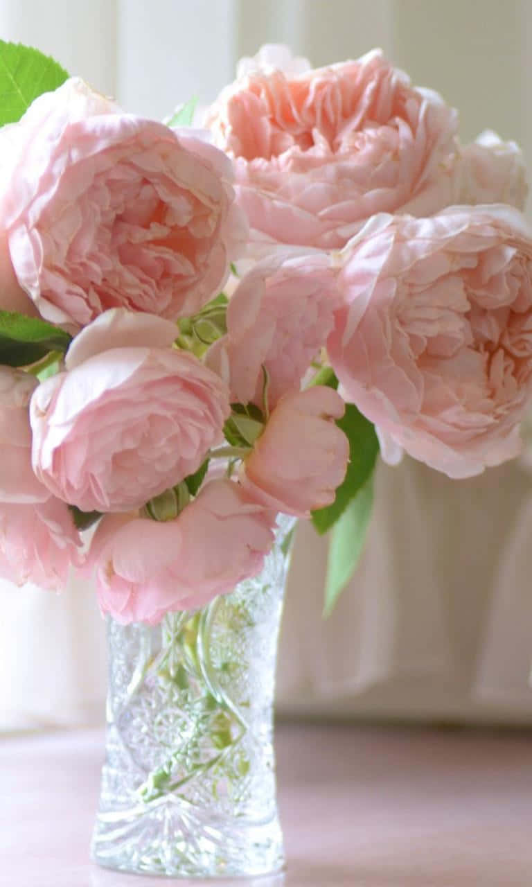 Pink Roses In A Glass Vase On A Table Wallpaper
