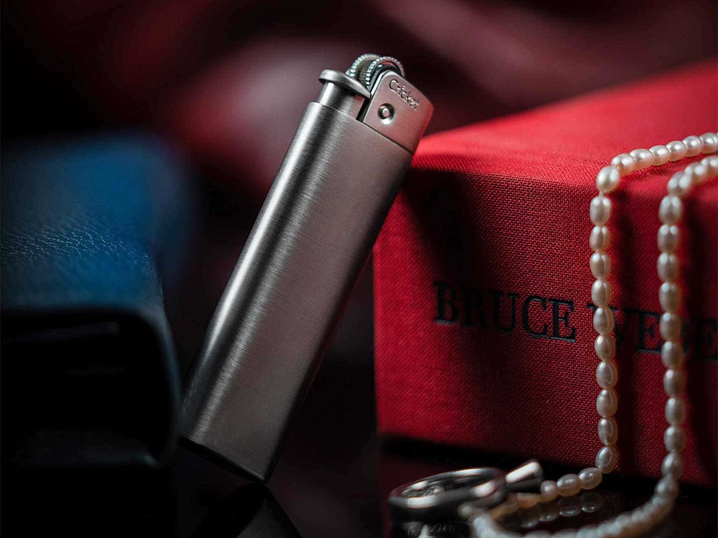 A Lighter With A Pearl Necklace And A Lighter