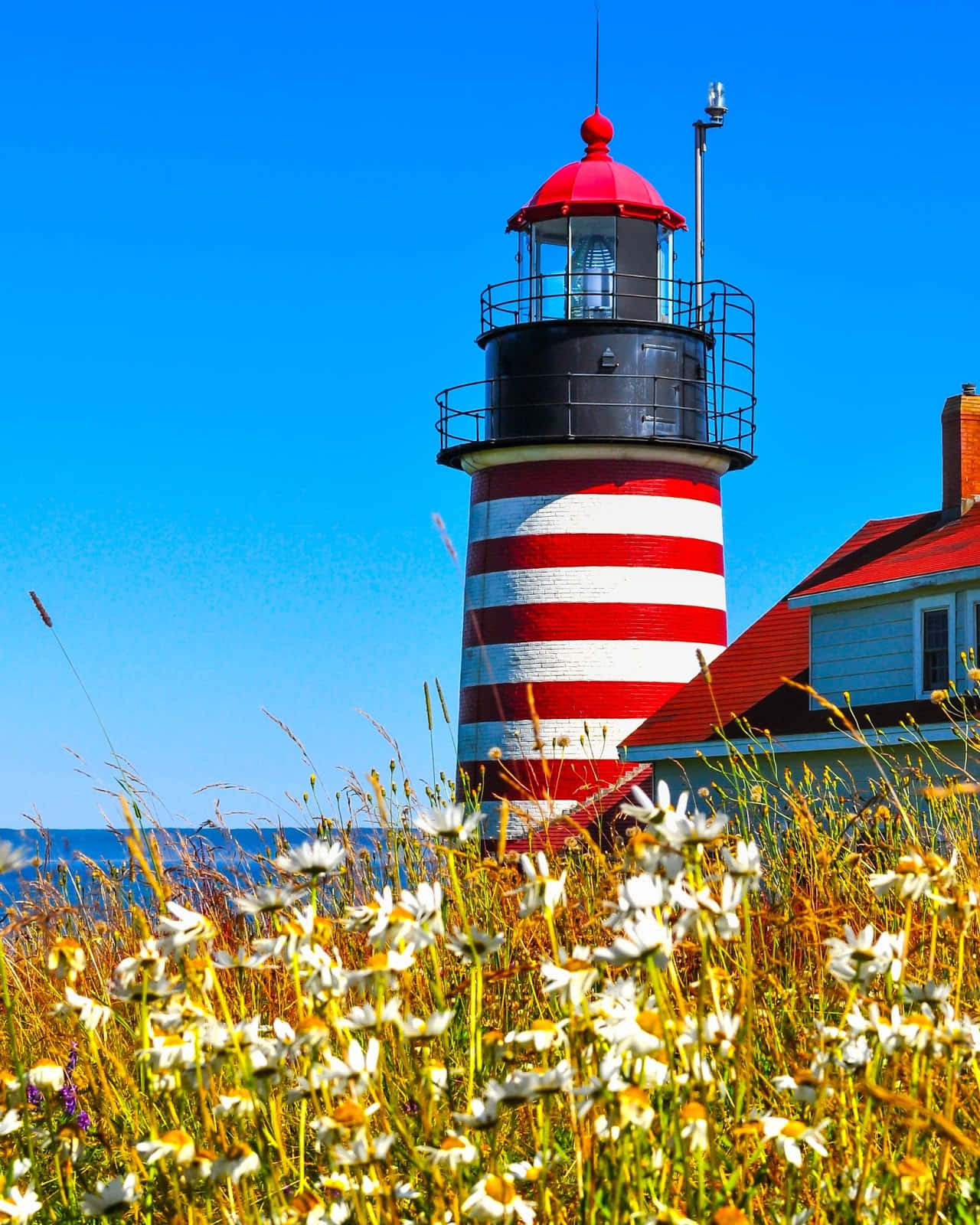 A Lighthouse With A Red And White Stripe
