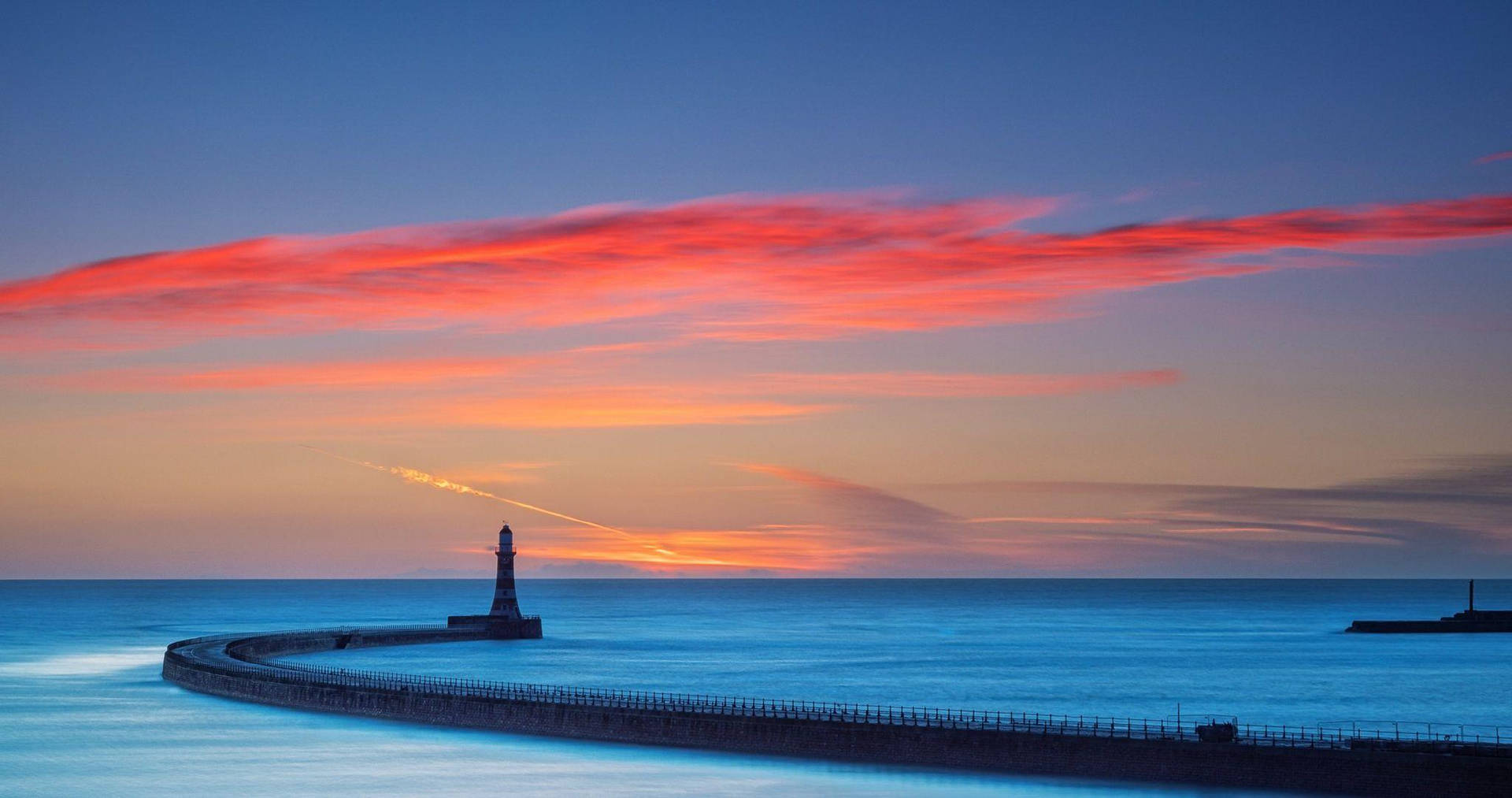 Lighthouse Under Sunset Clouds Wallpaper