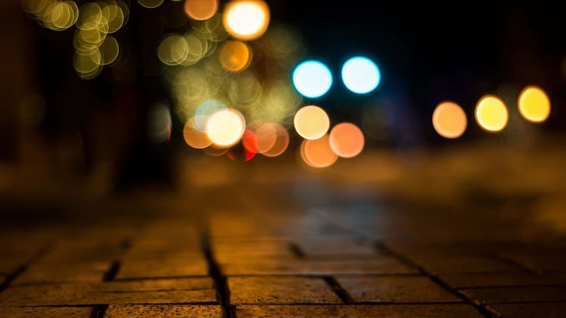 Blurrede lys på en mur-sidewalk om natten