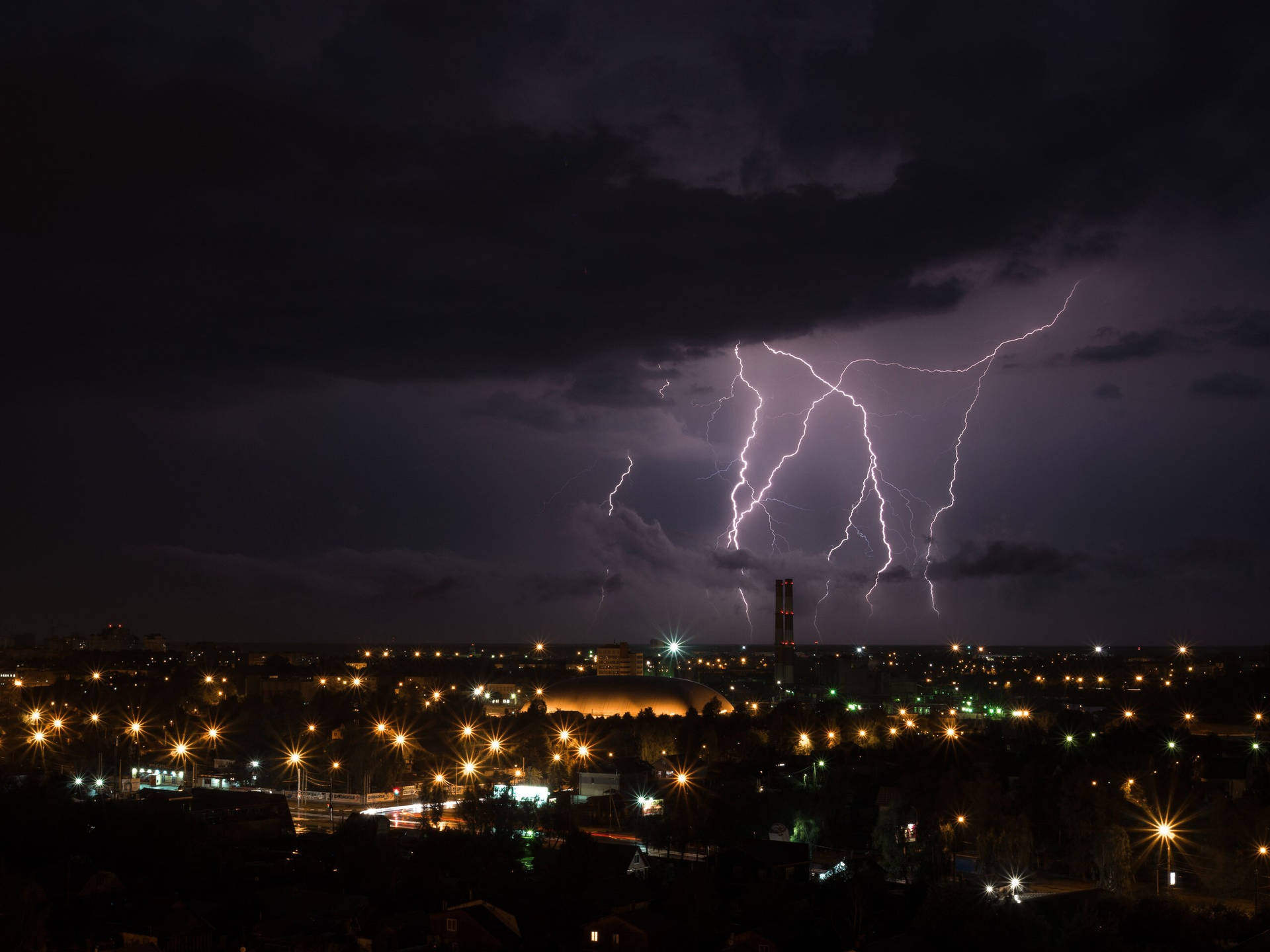 Bright Lightning Strikes Against The City Skyline Wallpaper