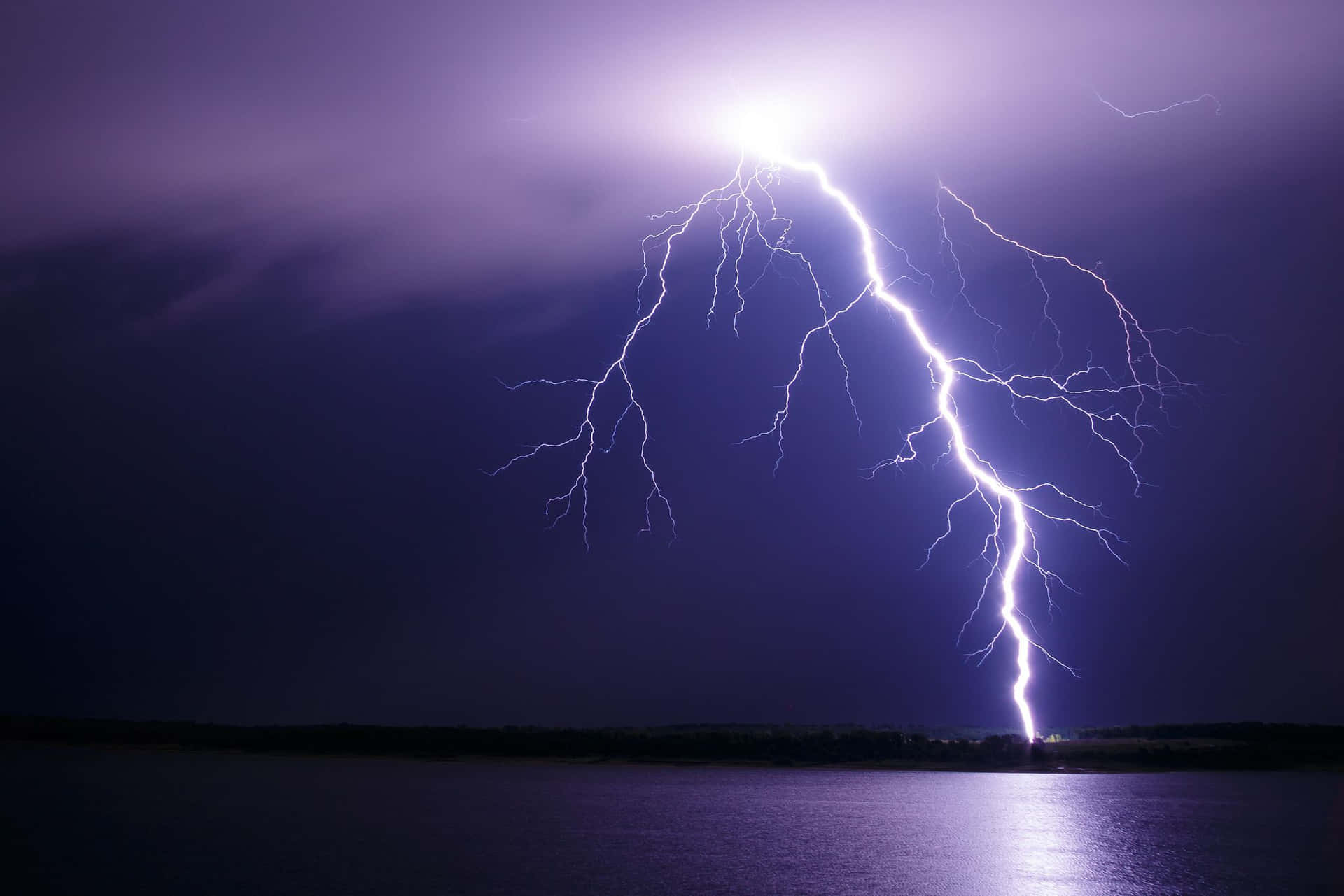 A bolt of lightning strikes at night