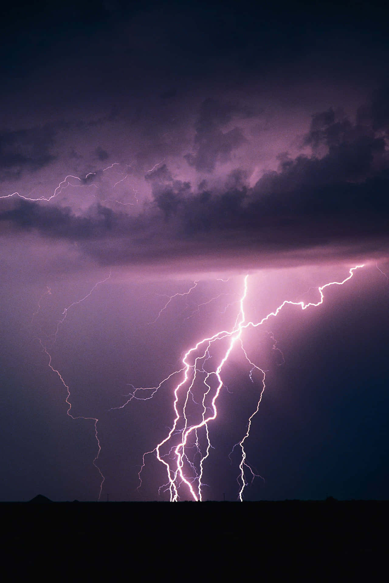 A powerful lightning bolt illuminates the sky