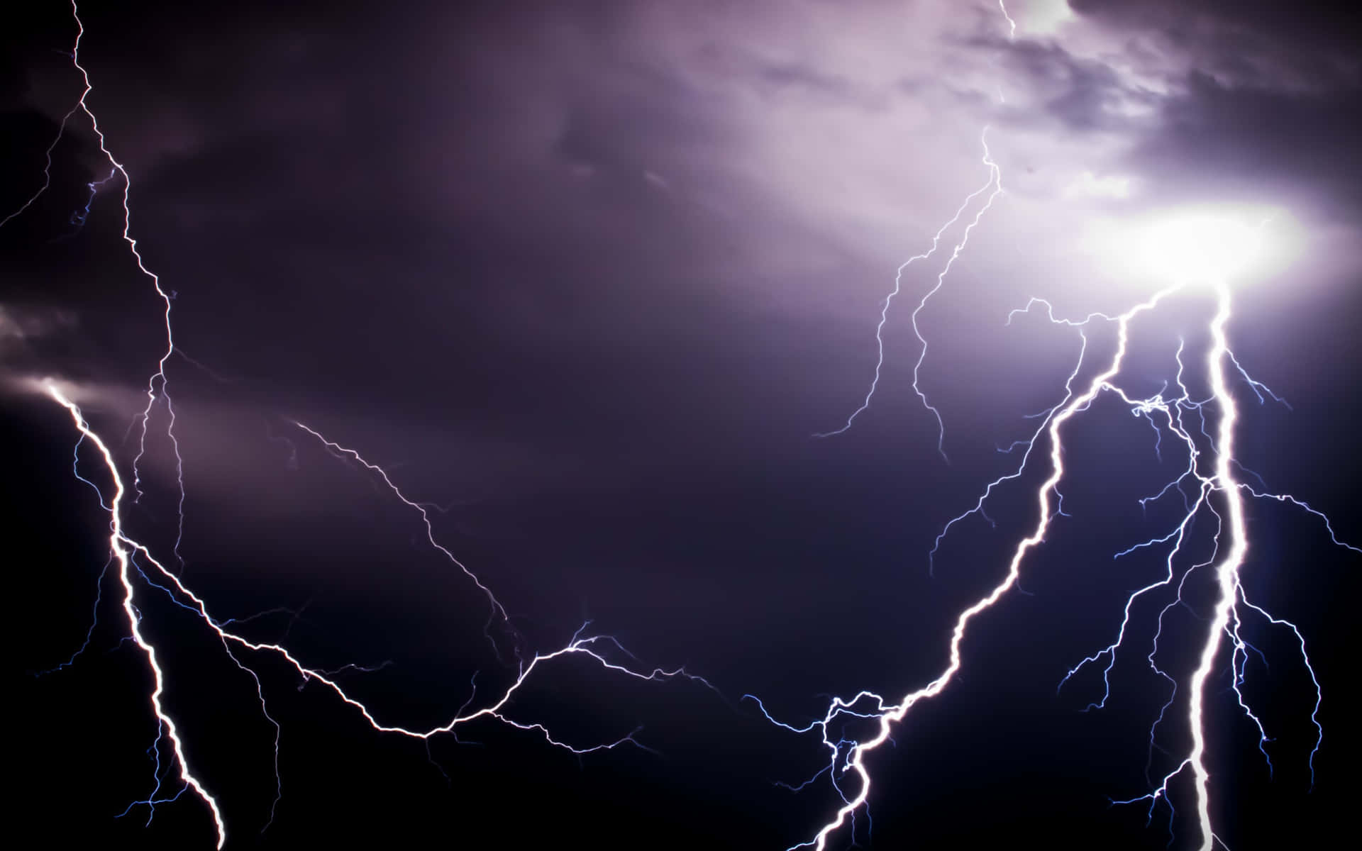 A powerful bolt of lightning striking at night