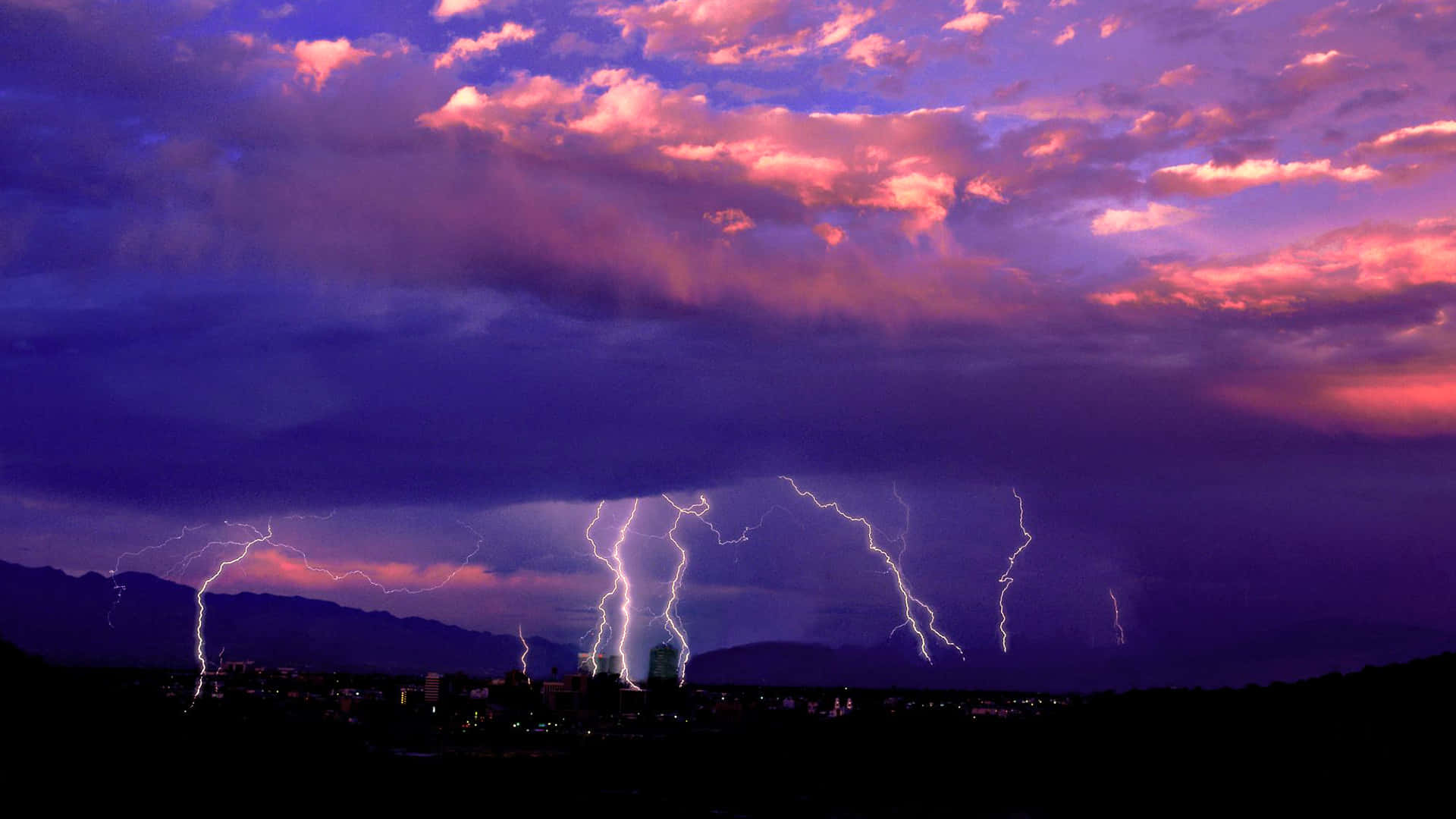 A breathtakingly powerful bolt of lightning strikes across a dark sky