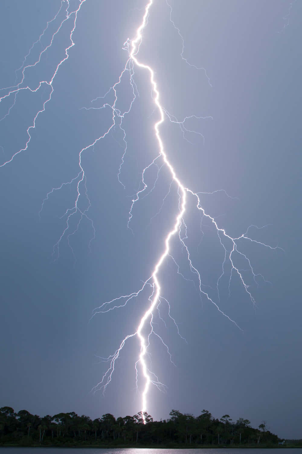 A lightning strike sparks alongside a dark sky