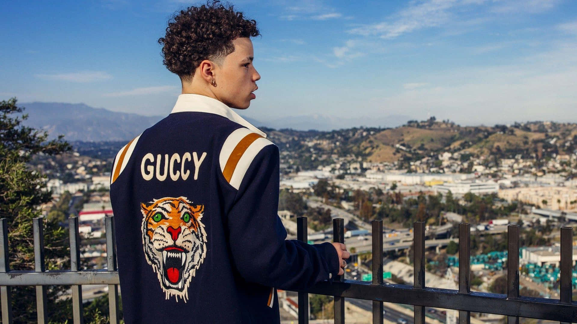 Lil Mosey exuding confidence as he stands in front of a sea of people Wallpaper