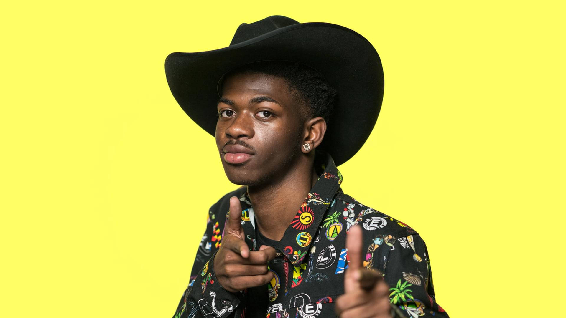 Lil Nas X In Yellow Background Wallpaper